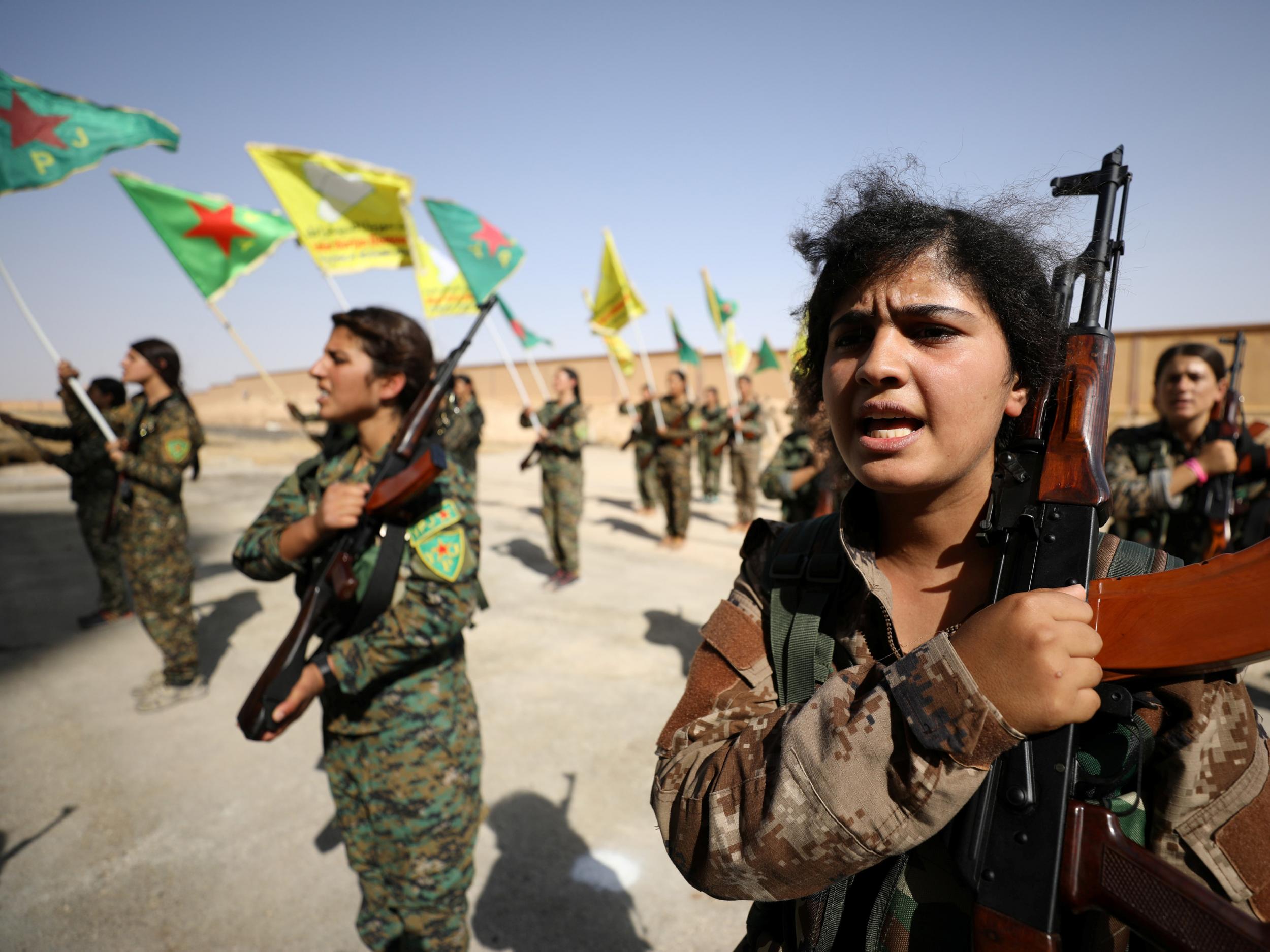 Syrian Democratic Forces female fighters hold their weapons during a graduation ceremony in the city of Hasaka, northeastern Syria on 9 August 2017