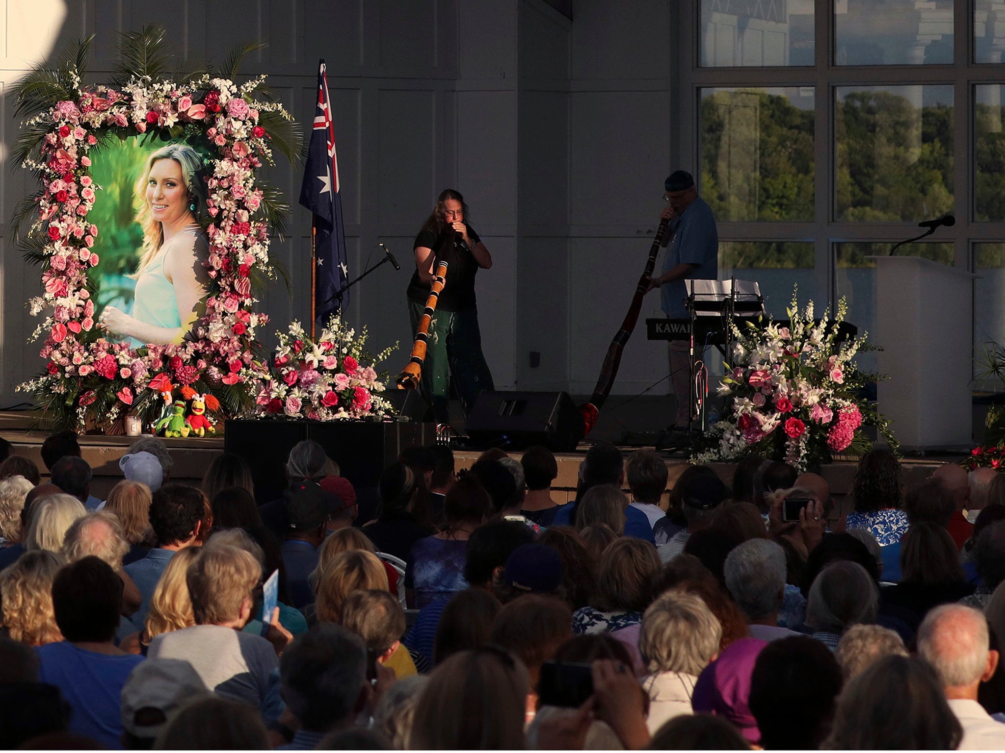 A pair of musicians play didgeridoos during the memorial service for Justine Damond, Friday, Aug. 11, 2017, at Lake Harriet in Minneapolis. Damond was killed by a Minneapolis police officer on July 15 after she called 911 to report a possible sexual assault near her home. (Anthony Souffle/Star Tribune via AP)