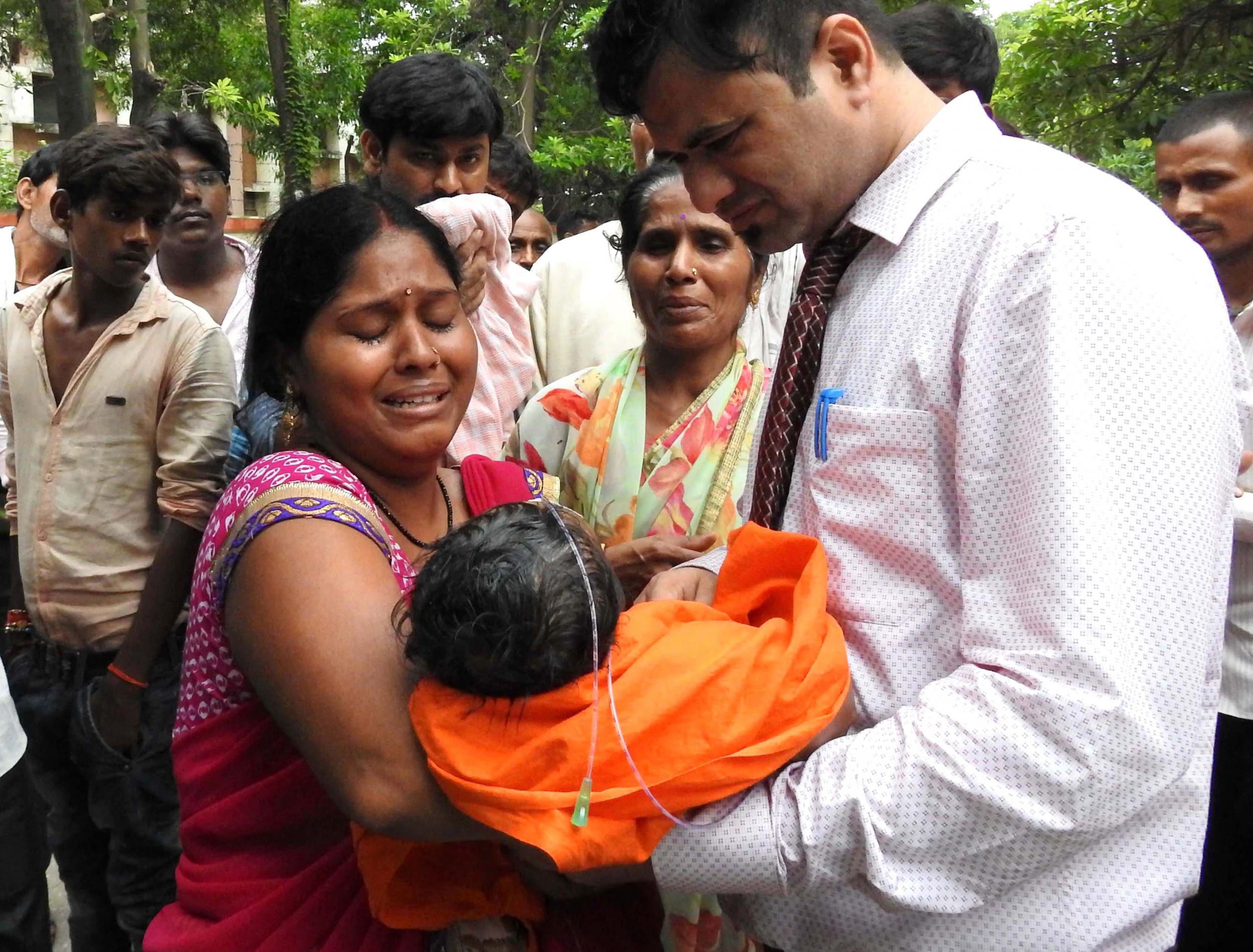 Relatives mourn the death of a child at the Baba Raghav Das Hospital in Gorakhpur