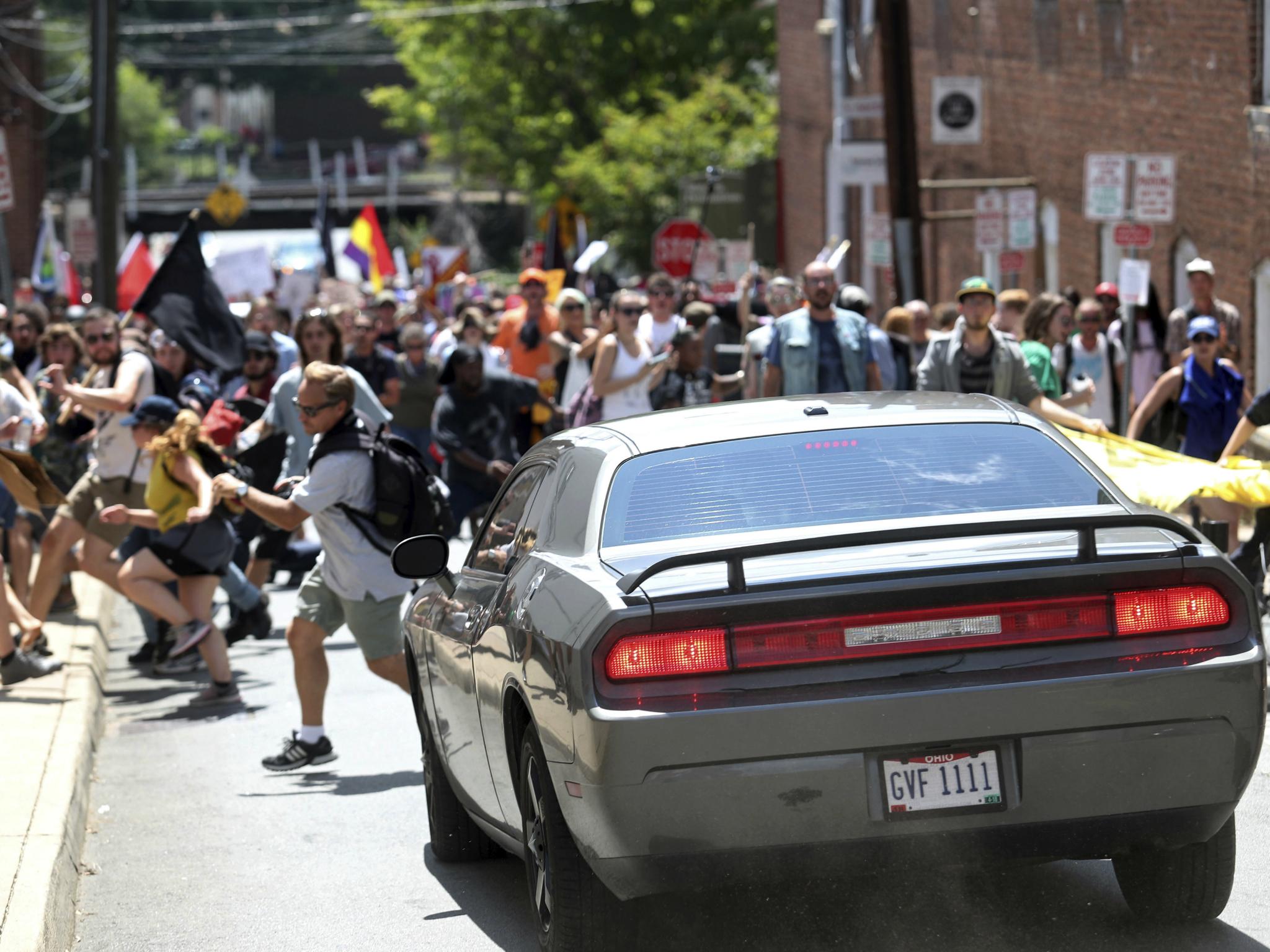 A car drives into protesters in Charlottesville, Virginia. One person was killed and more were injured