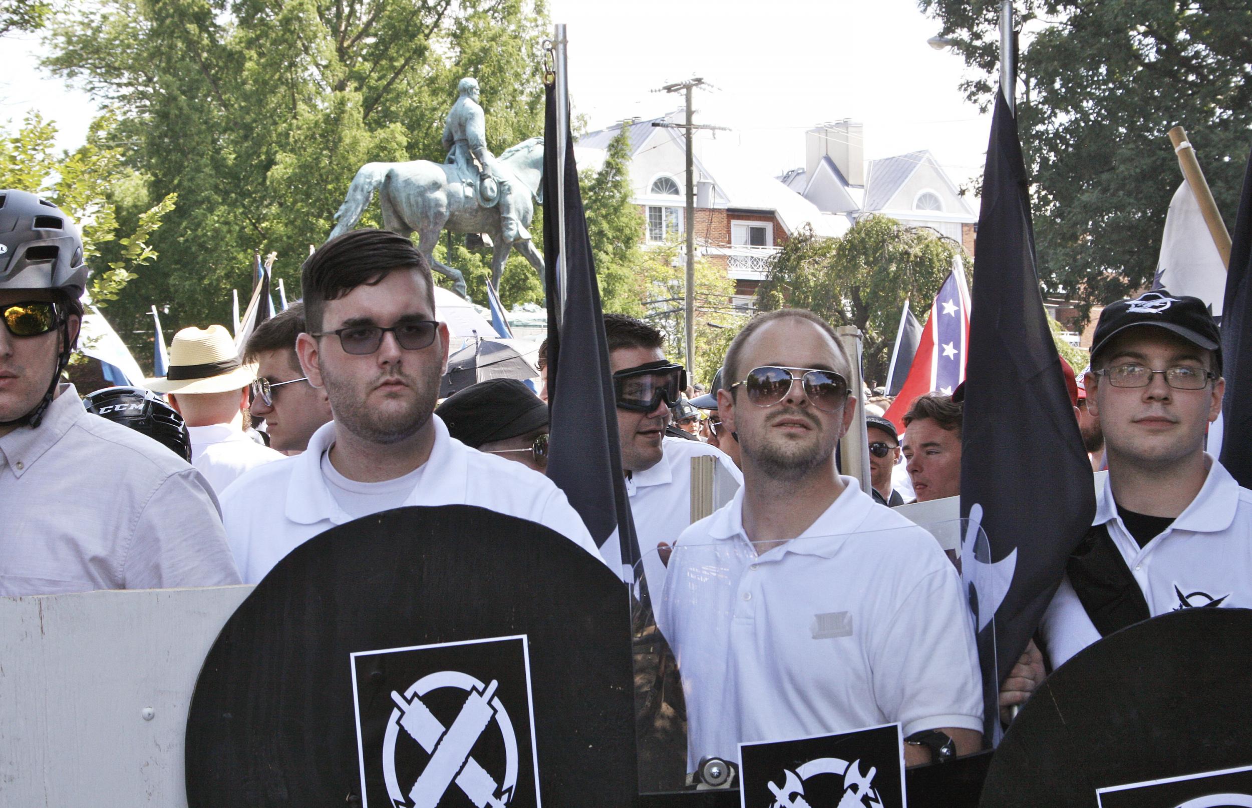 James Fields, second from left, was pictured holding a black shield in Charlottesville hours before he drove a car into a group of anti-fascist protesters