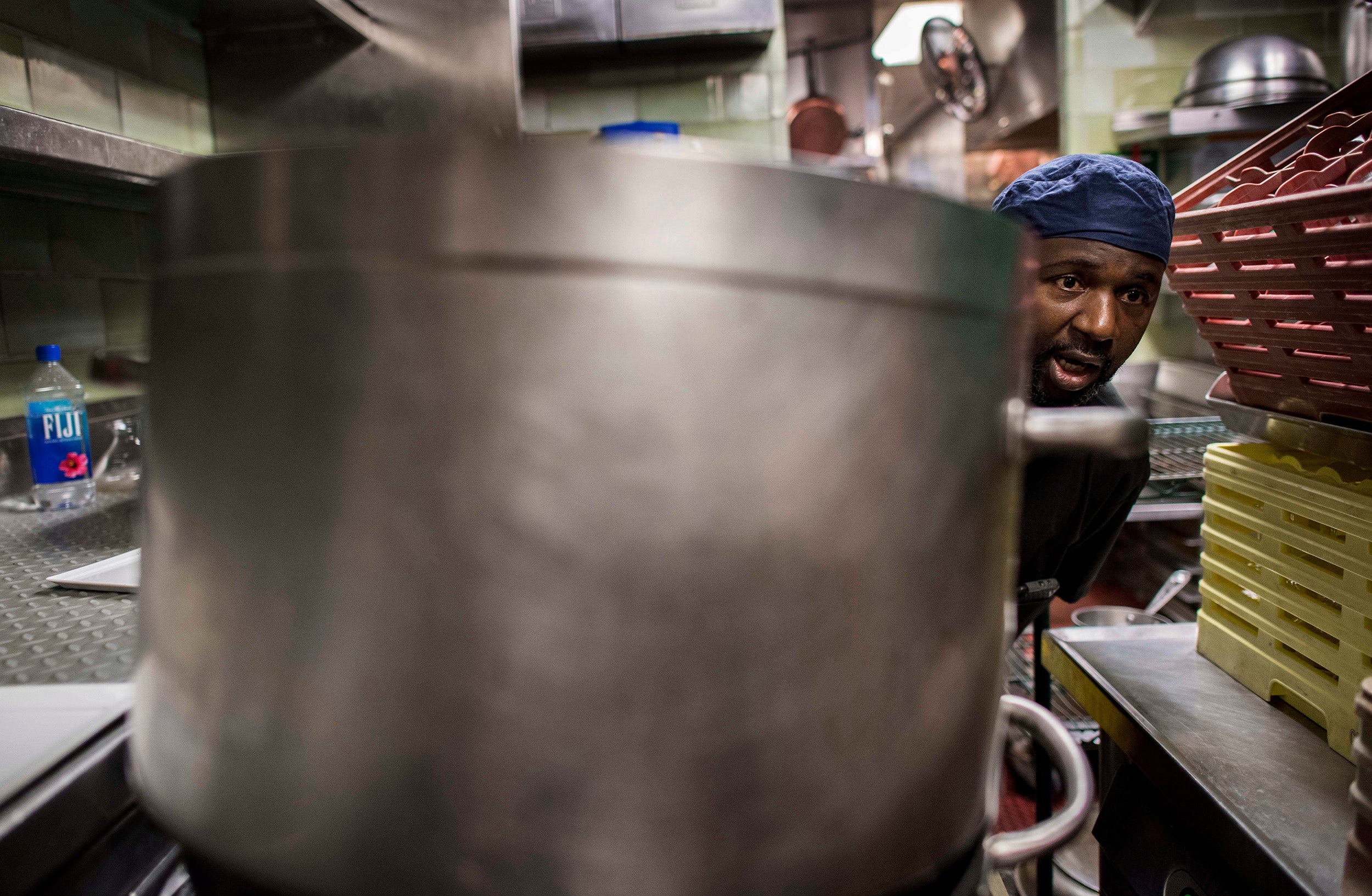 &#13;
Pots the size of planters: Abdoul Sylla works in the kitchen of Daniel, one of chef Daniel Boulud's restaurants in New York &#13;