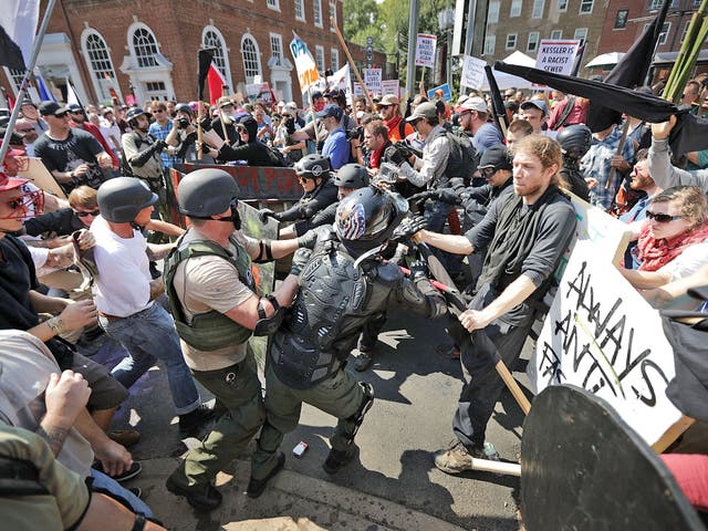 File. White nationalists, neo-Nazis and members of the alt-right clash with counter-protesters as they enter Lee Park during the Unite the Right rally 12 August 2017 in Charlottesv