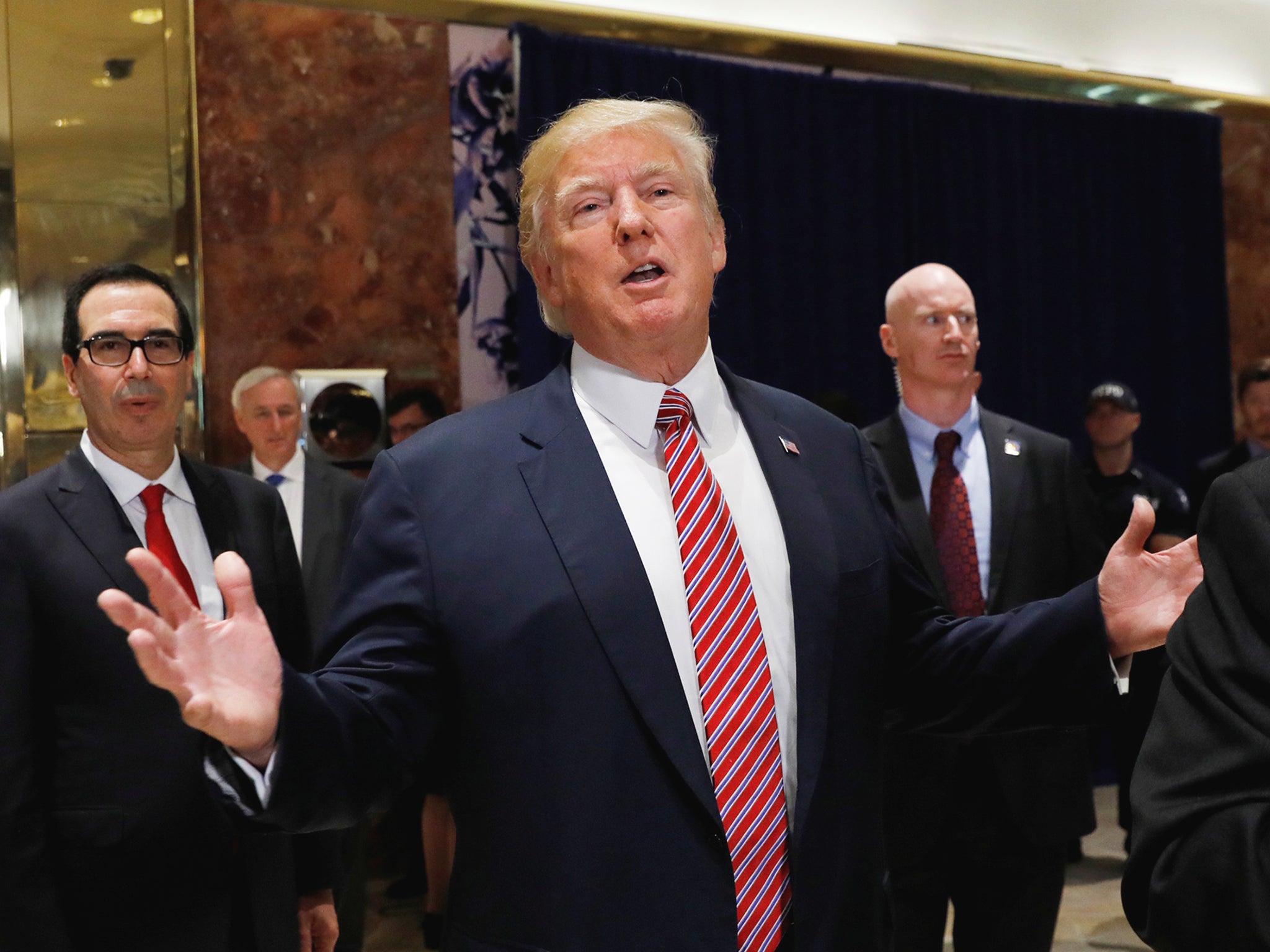 President Donald Trump stops to respond to more questions about his responses to the violence, injuries and deaths at the 'Unite the Right' rally in Charlottesville