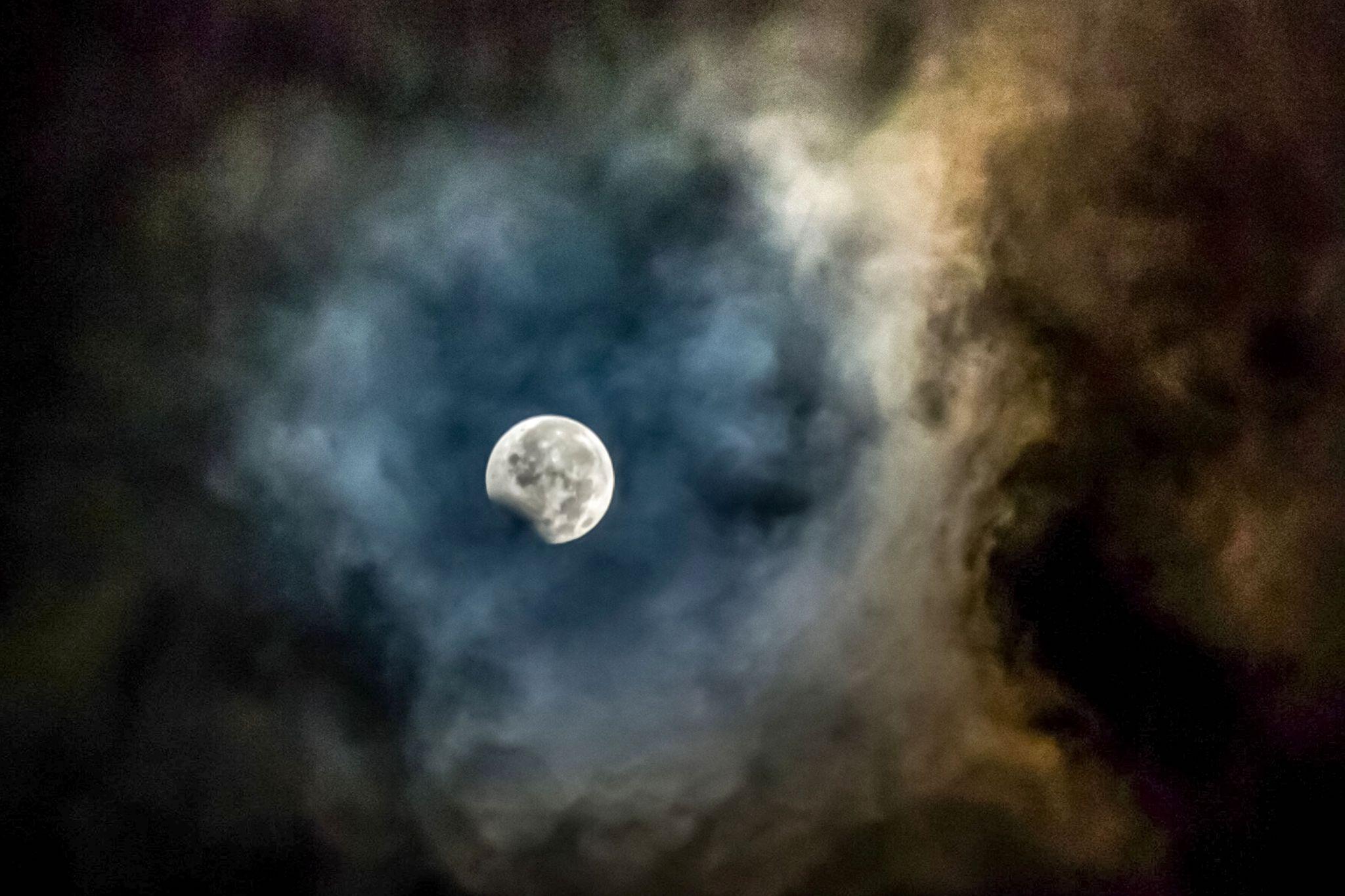 The moon, framed by ashes from the Mount Sinabung volcano, is seen during the peak of the penumbral eclipse from Karo in North Sumatra province on August 8, 2017