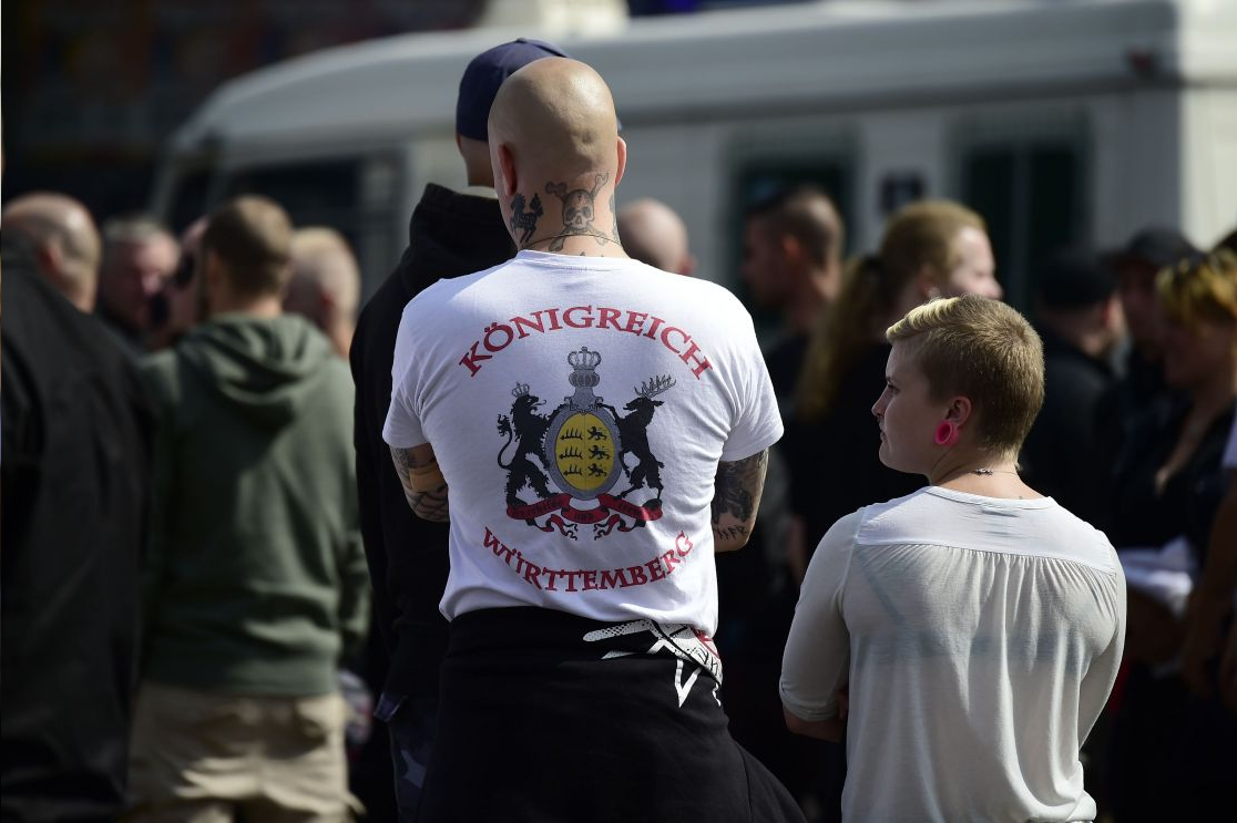 Police detain a counter-protester as fellow counter-protesters block a street as they attend a demonstration against a gathering of far-right organisations commemorating the 30th death anniversary Rudolf Hess in the district of Spandau in Berlin, Germany,