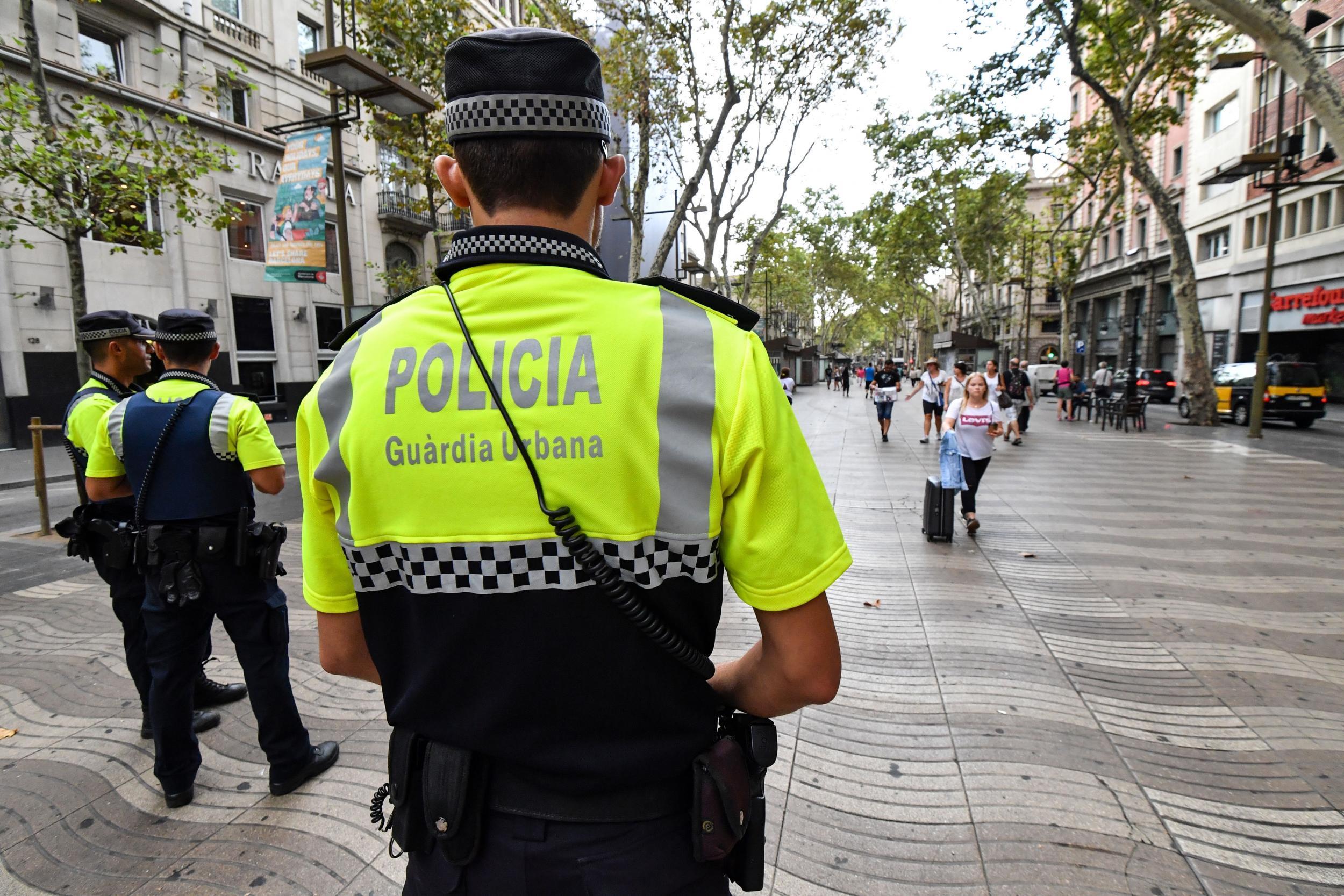 Police officers stand guard on La Rambla