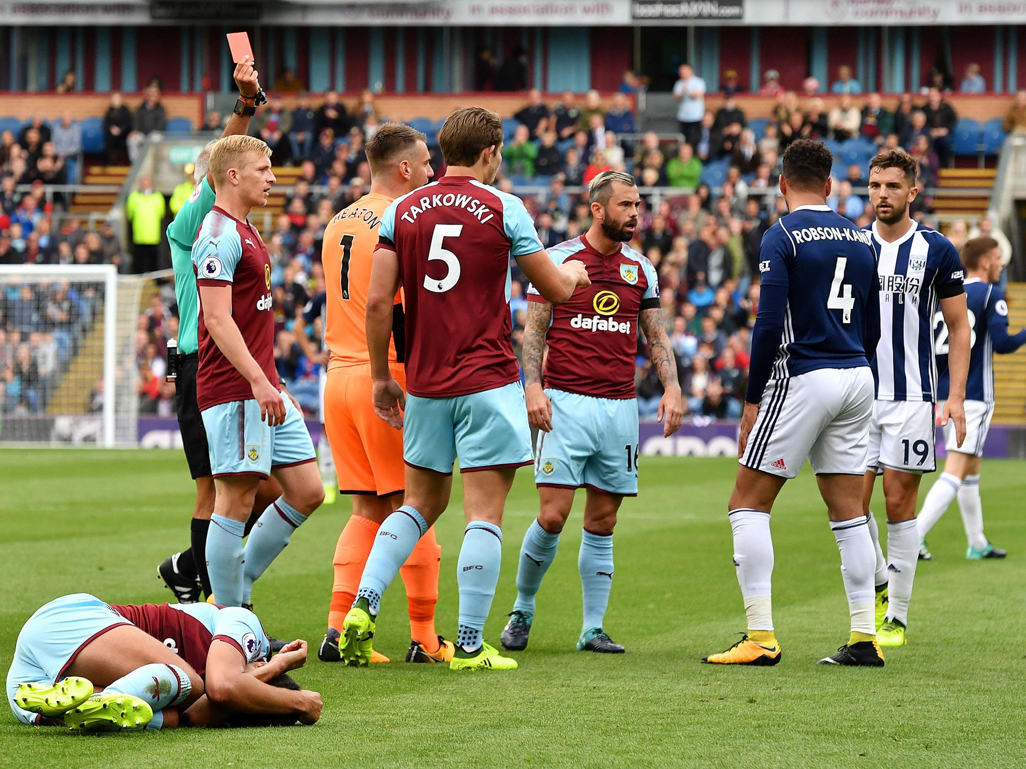 Hal Robson-Kanu is shown a straight red card for an elbow to Matt Lowton