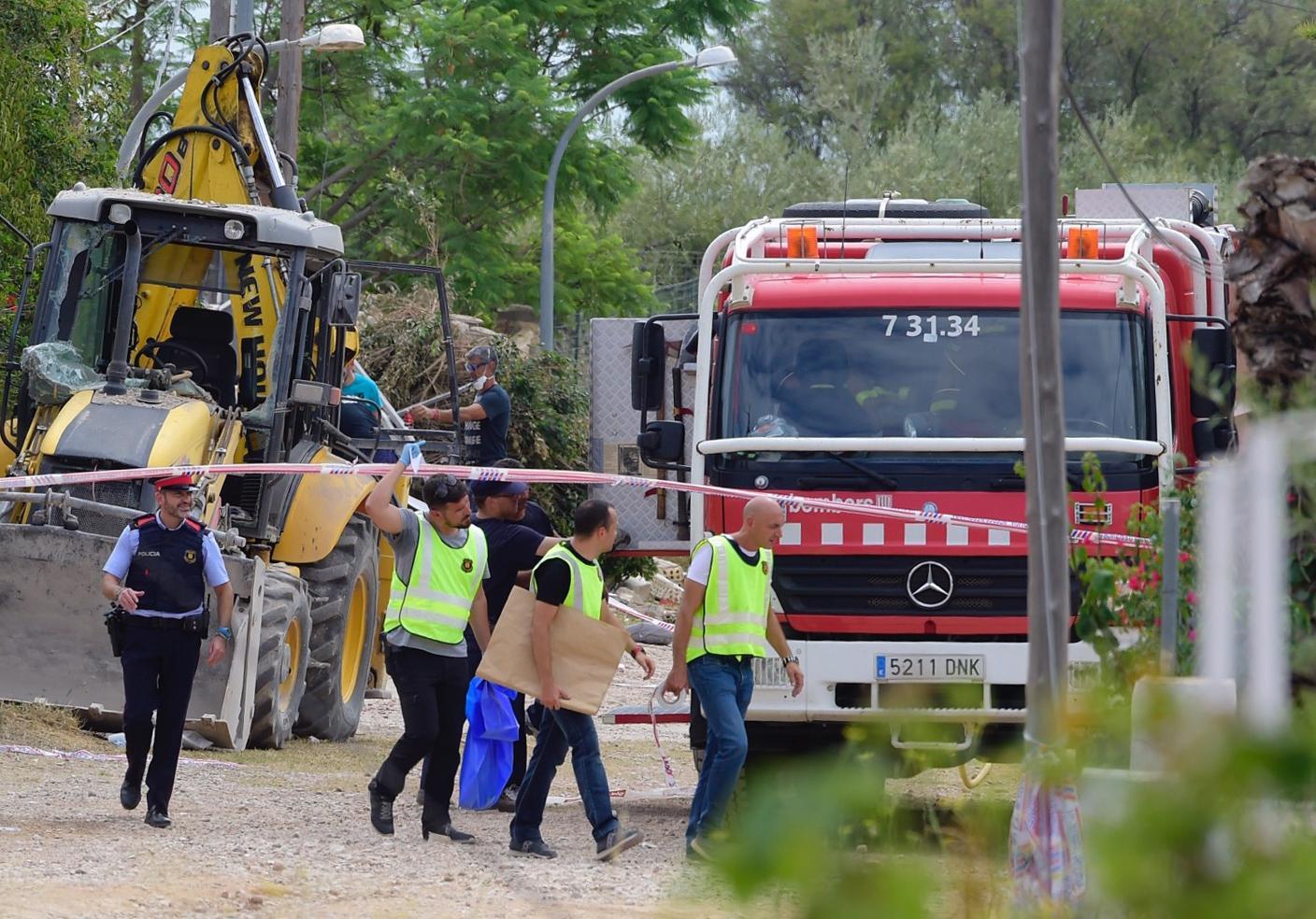 Police officers investigate the rubble of the house in Alcanar on Sunday