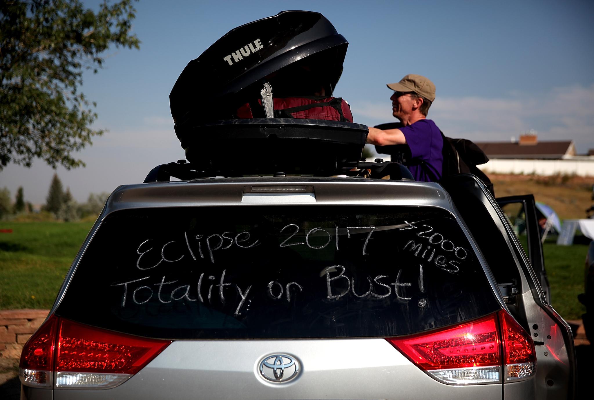 Brian Marriott of Boston, Massachusetts looks in a storage container on top of his car before watching the solar eclipse at South Mike Sedar Park on August 21, 2017 in Casper, Wyoming