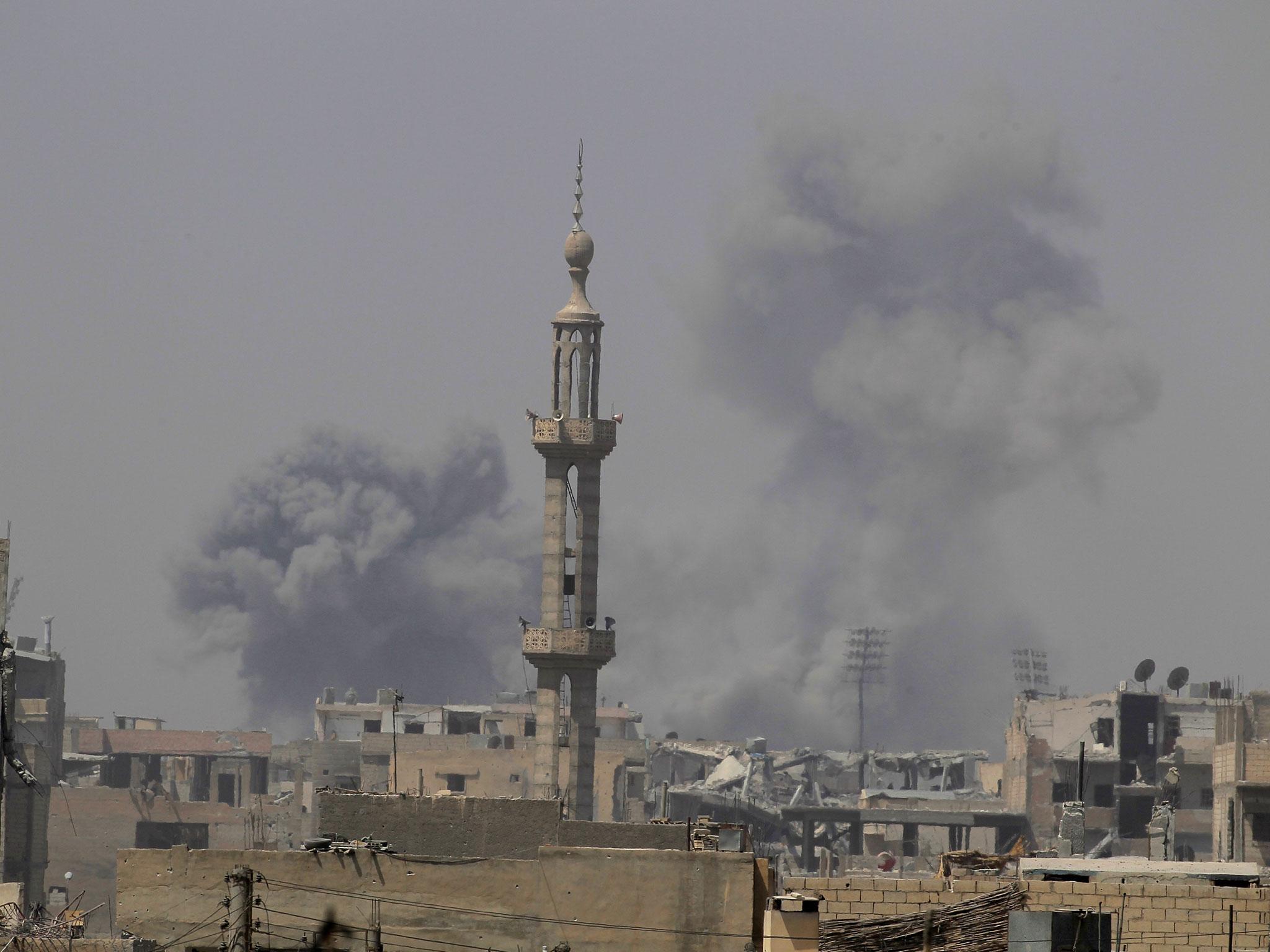 Smoke rises after an air strike during fighting between members of the Syrian Democratic Forces and Islamic State militants in Raqqa, Syria