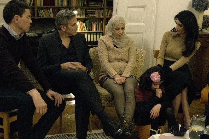 Handout photo of Miliband, Clooney and Amal meeting with Syrian refugees in Berlin