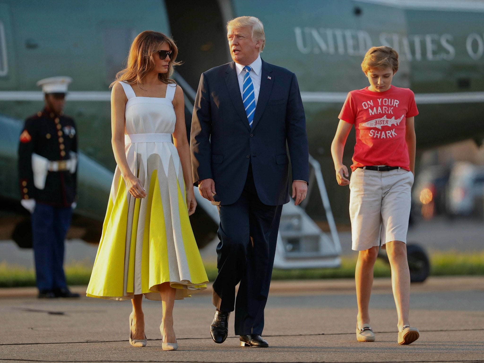 President Donald Trump, first lady Melania Trump and son Barron Trump walk across the tarmac in Morristown, N.J., on Aug. 20, 2017.