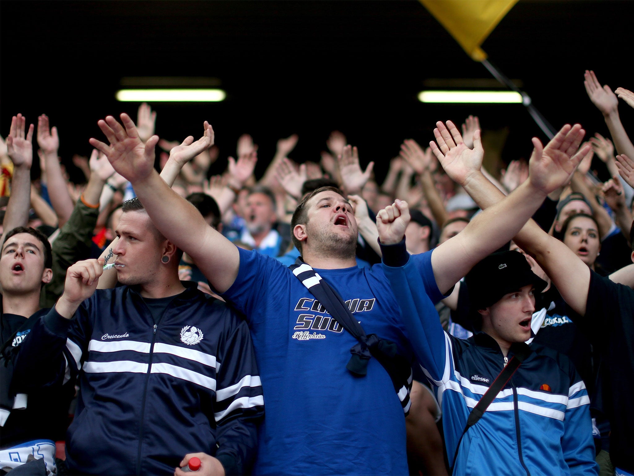 A Hoffenheim fan brushes his teeth at Anfield