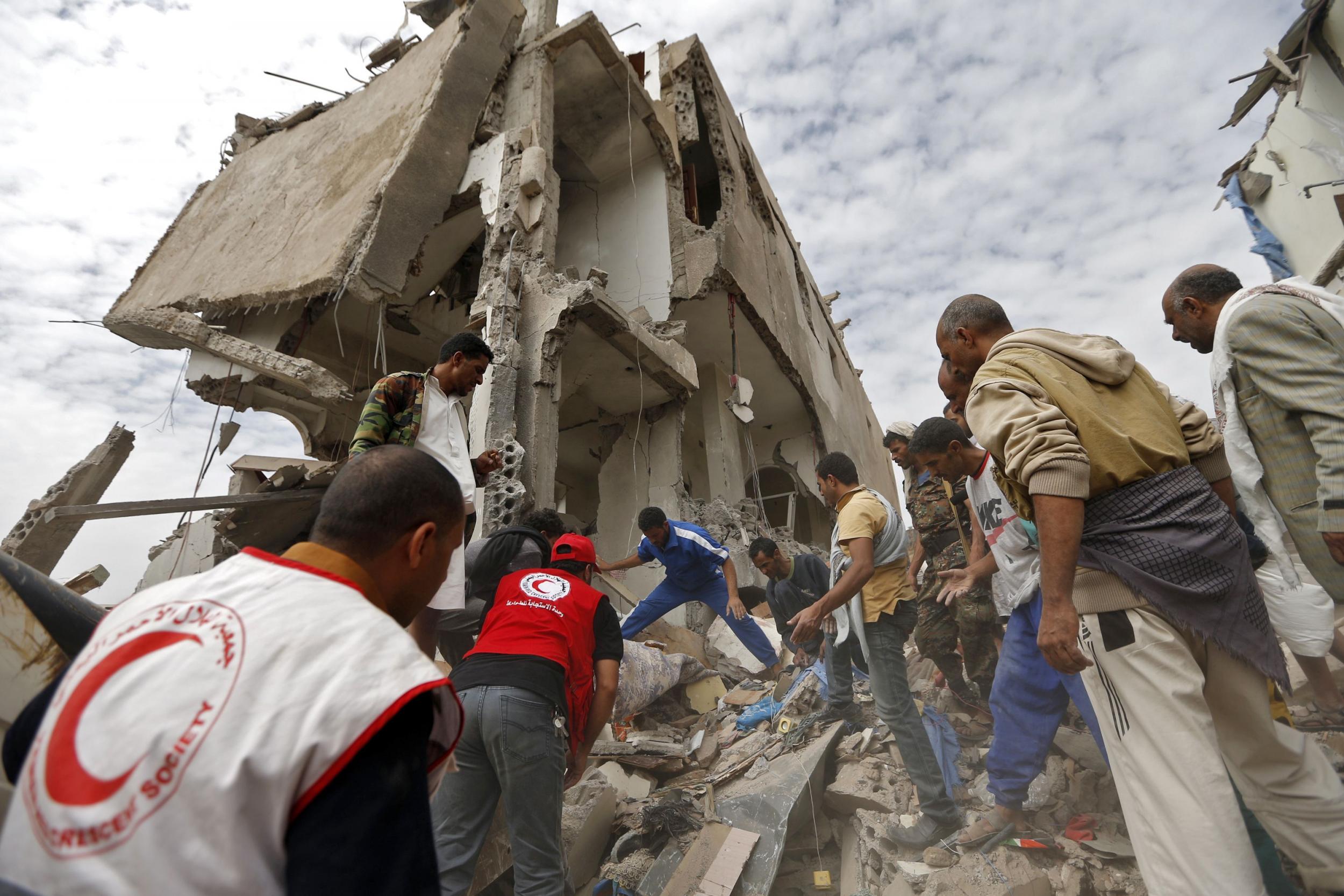 Rescuers search under the rubble of a house destroyed in an air strike in the residential Faj Attan district of the the Yemeni capital Sanaa on 25 August 2017