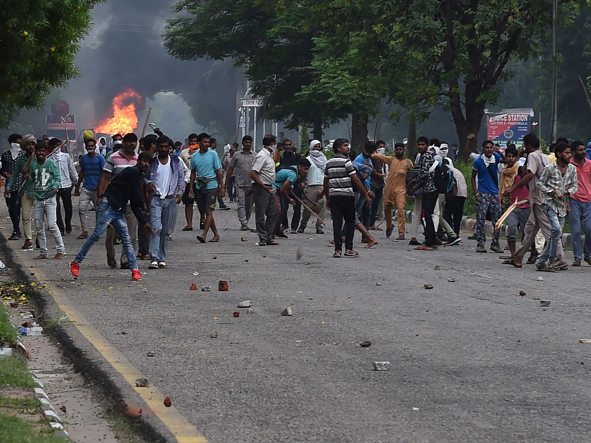 Followers of Singh throw stones at security forces during clashes in Panchkula