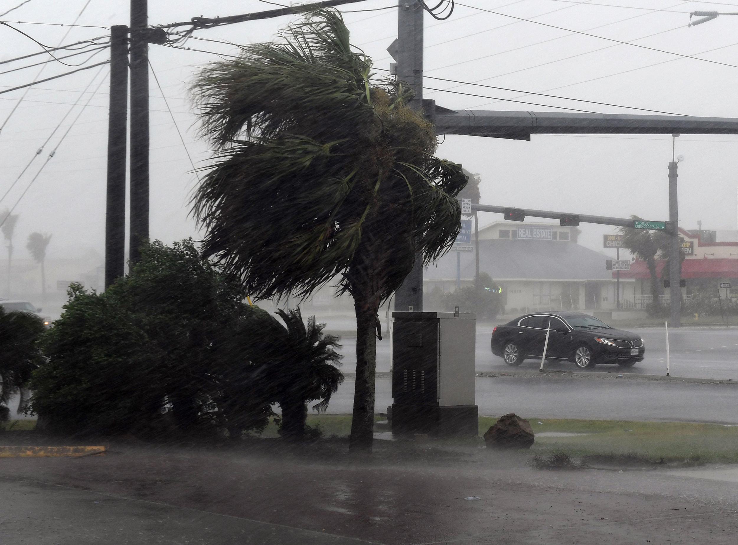 A motorist drives through heavy rain before the approaching Hurricane Harvey hits Corpus Christi