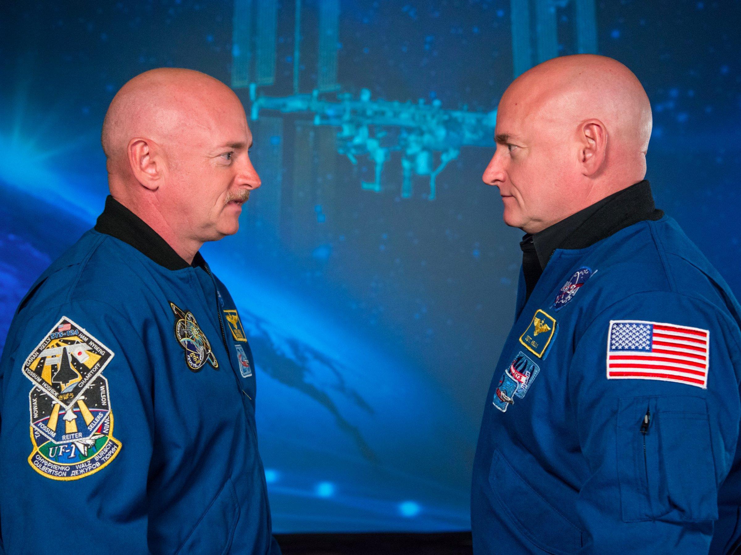 Astronaut Scott Kelly (R) stands alongside his identical twin brother Mark on January 19, 2015.