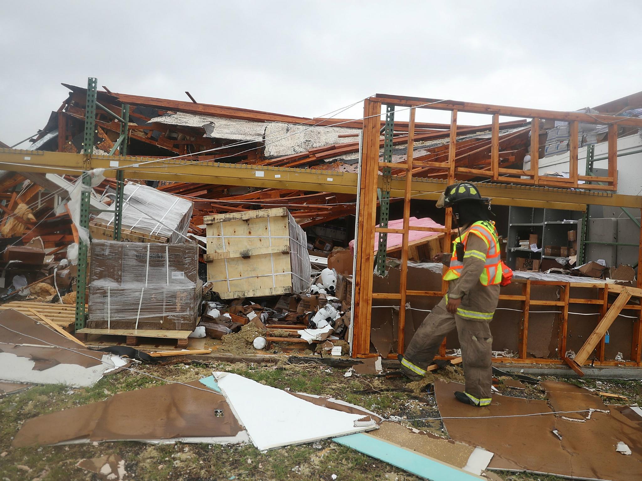 A Rockport firefighter goes door to door on a search and rescue mission as he looks for people that may need help after Hurricane Harvey passed through on 26 August 2017 in Rockport, Texas, just north of Port Aransas