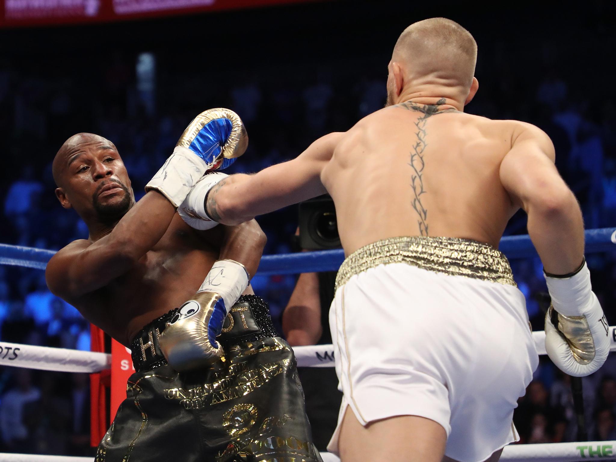 Floyd Mayweather evades a Conor McGregor left jab