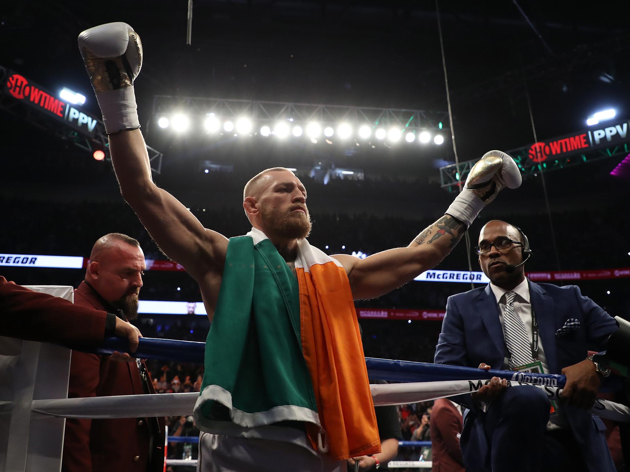 Conor McGregor arrives in the ring first.