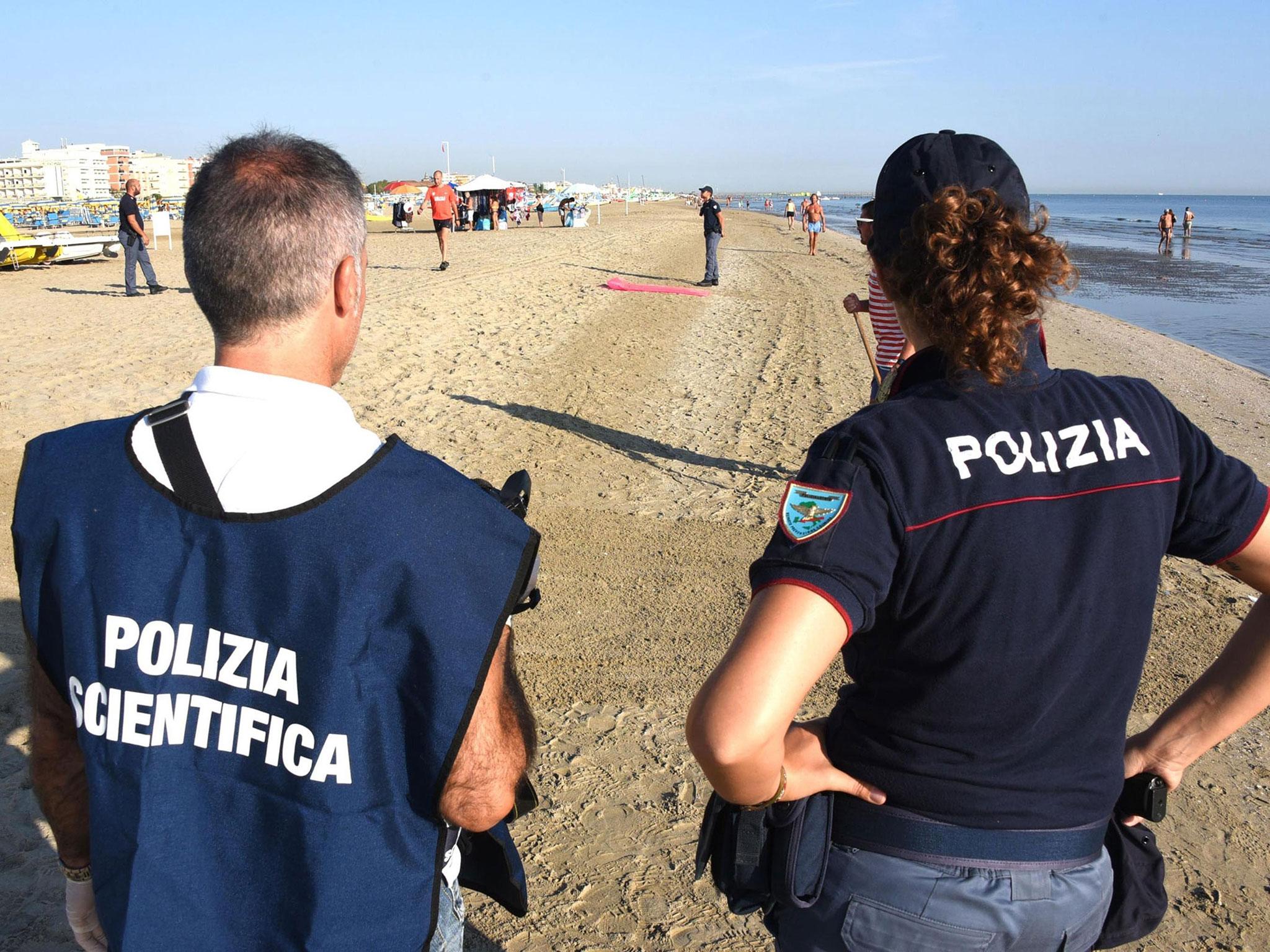 Italian Scientific Police investigate the site where a couple of Polish tourists were attacked by four men, in Miramare in Rimini