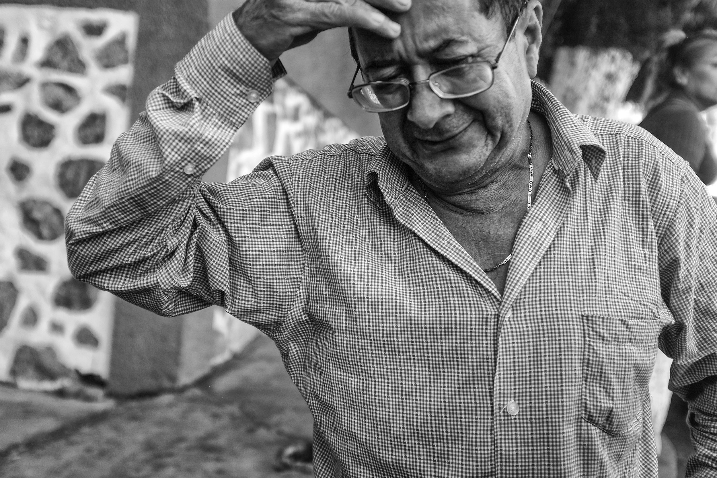 Gerardo Flores Camarena weeps at the morgue after identifying the bodies of his grandsons