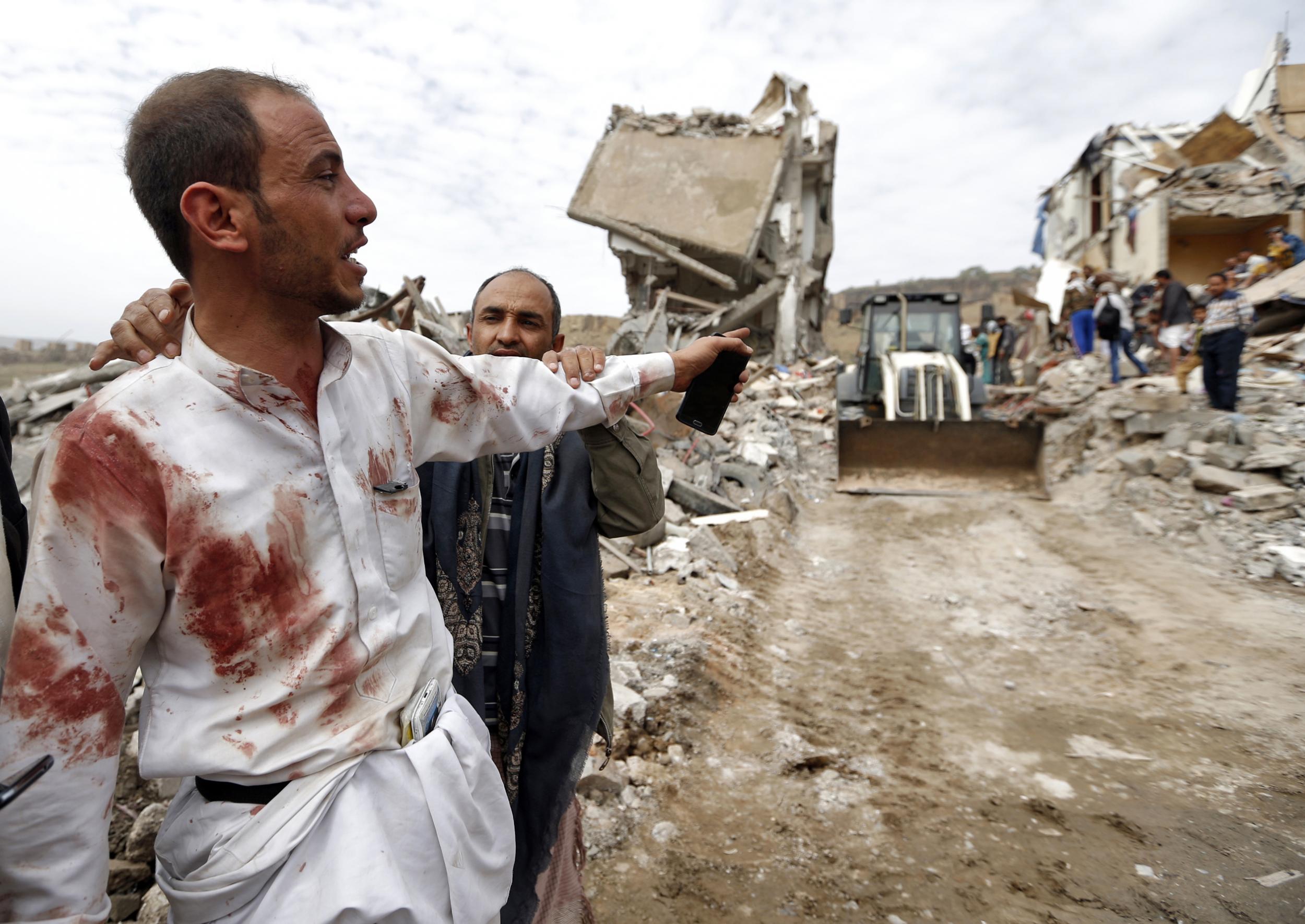 Locals search for survivors in the debris of buildings hit in an Saudi coalition air strike in the residential Faj Attan district of the Yemeni capital of Sanaa on 25 August 2017