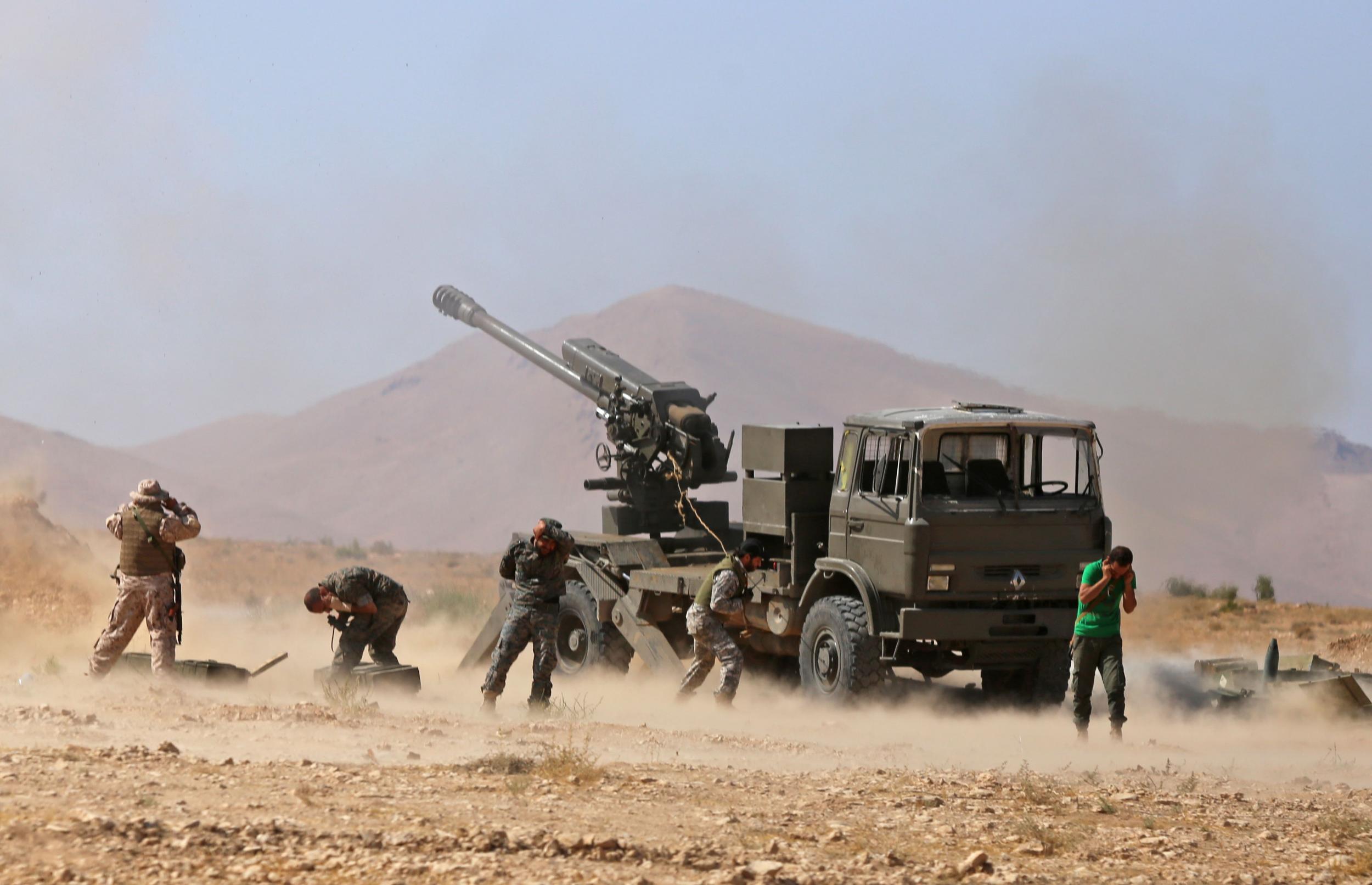 Syrian pro-government forces fire towards jihadist positions in western Qalamoun on 23 August 2017