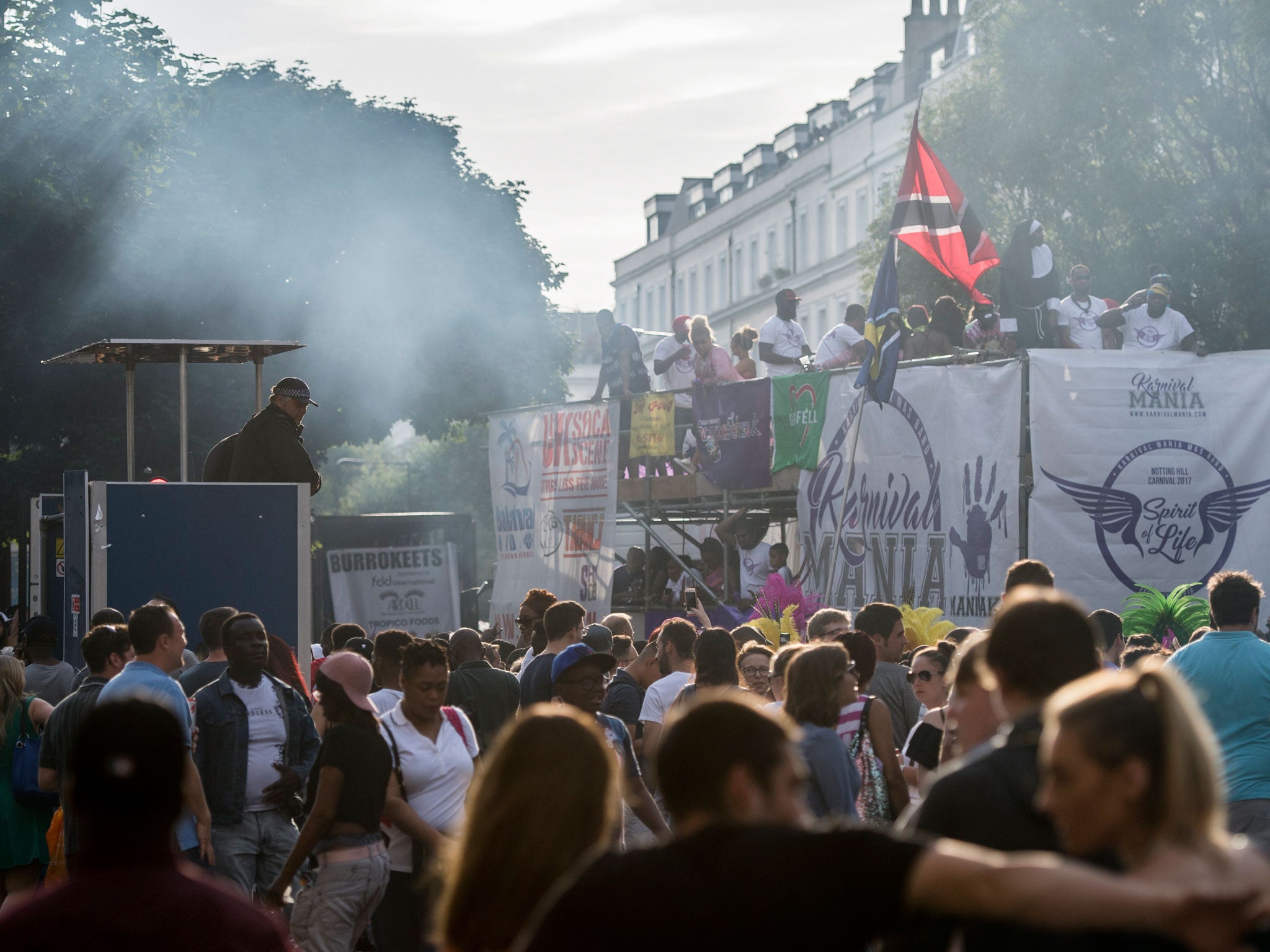 A police officer watches revellers at Notting Hill Carnival