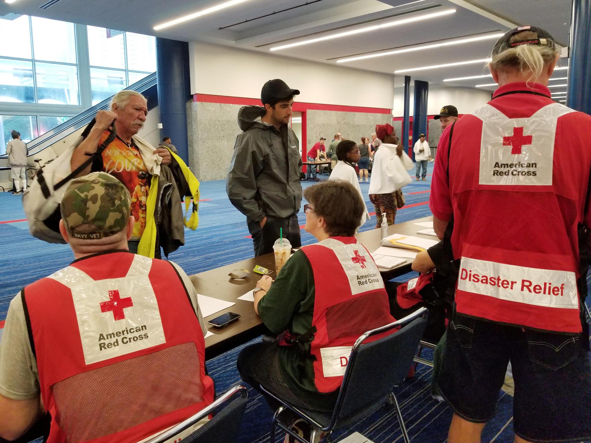 Evacuees arrive to seek shelter with Red Cross volunteers at the George Brown convention centre after flood waters of Hurricane Harvey forced them to leave their homes in Houston, Texas, on 27 August 201