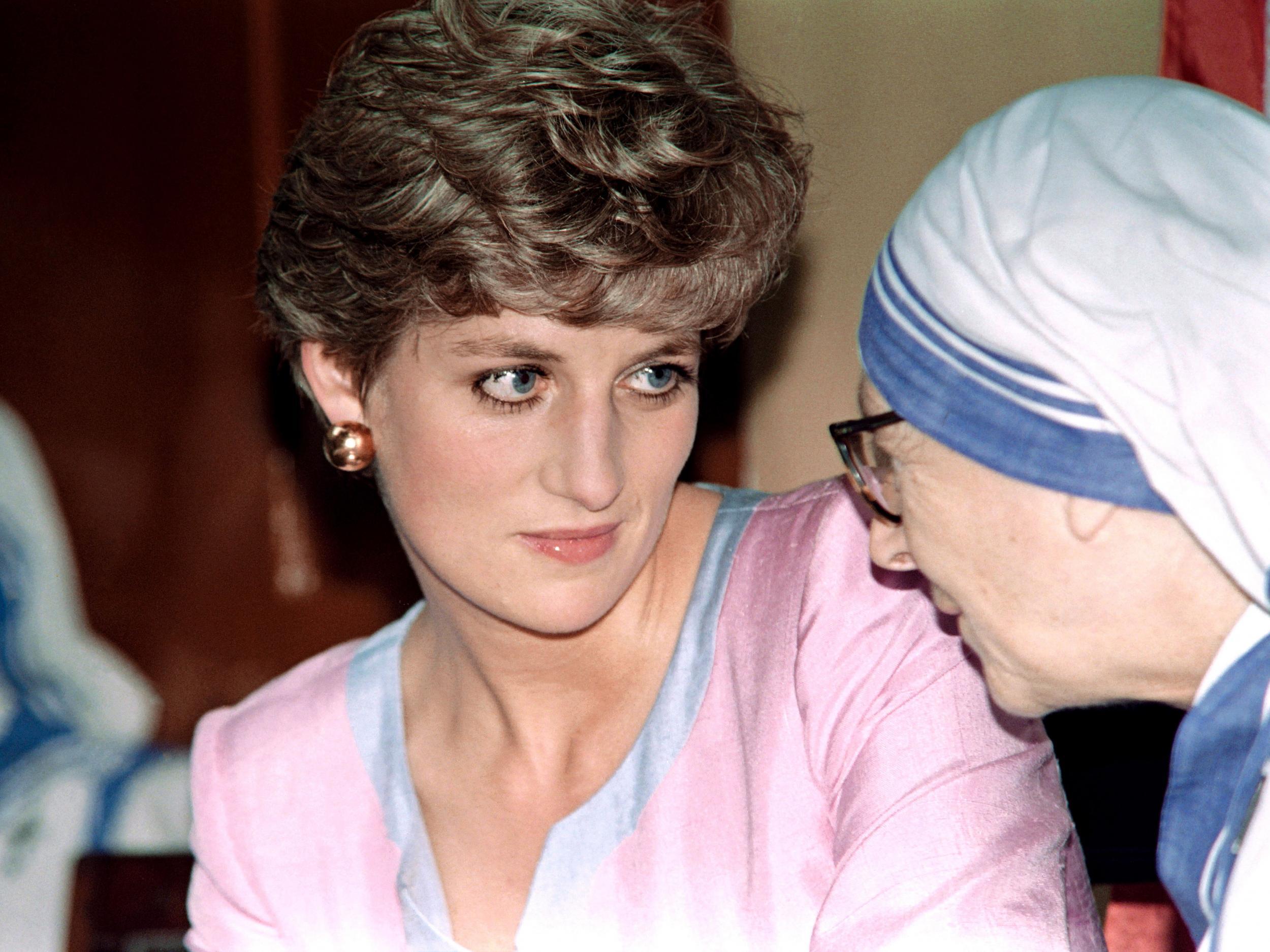 Diana listens to a senior nun of the Missionaries of Charity at the house of Mother Teresa in Calcutta on 15 February, 1992