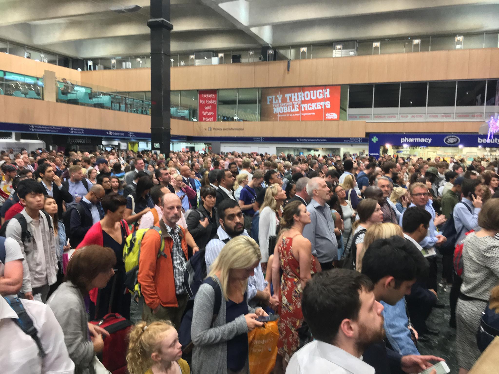 Passengers waiting for service to resume after Euston station was evacuated because of a "small explosion"