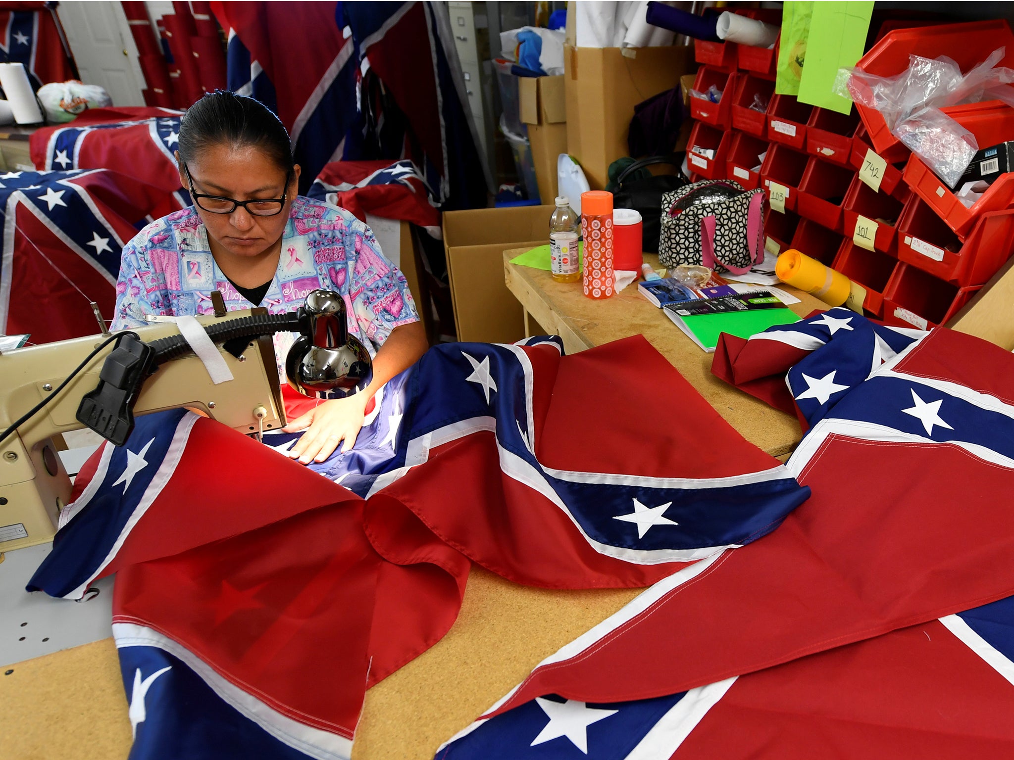 Blanca Hernandez sews stars on a Confederate Battle Flag in the Alabama Flag & Banner shop in Huntsville, Alabama, US