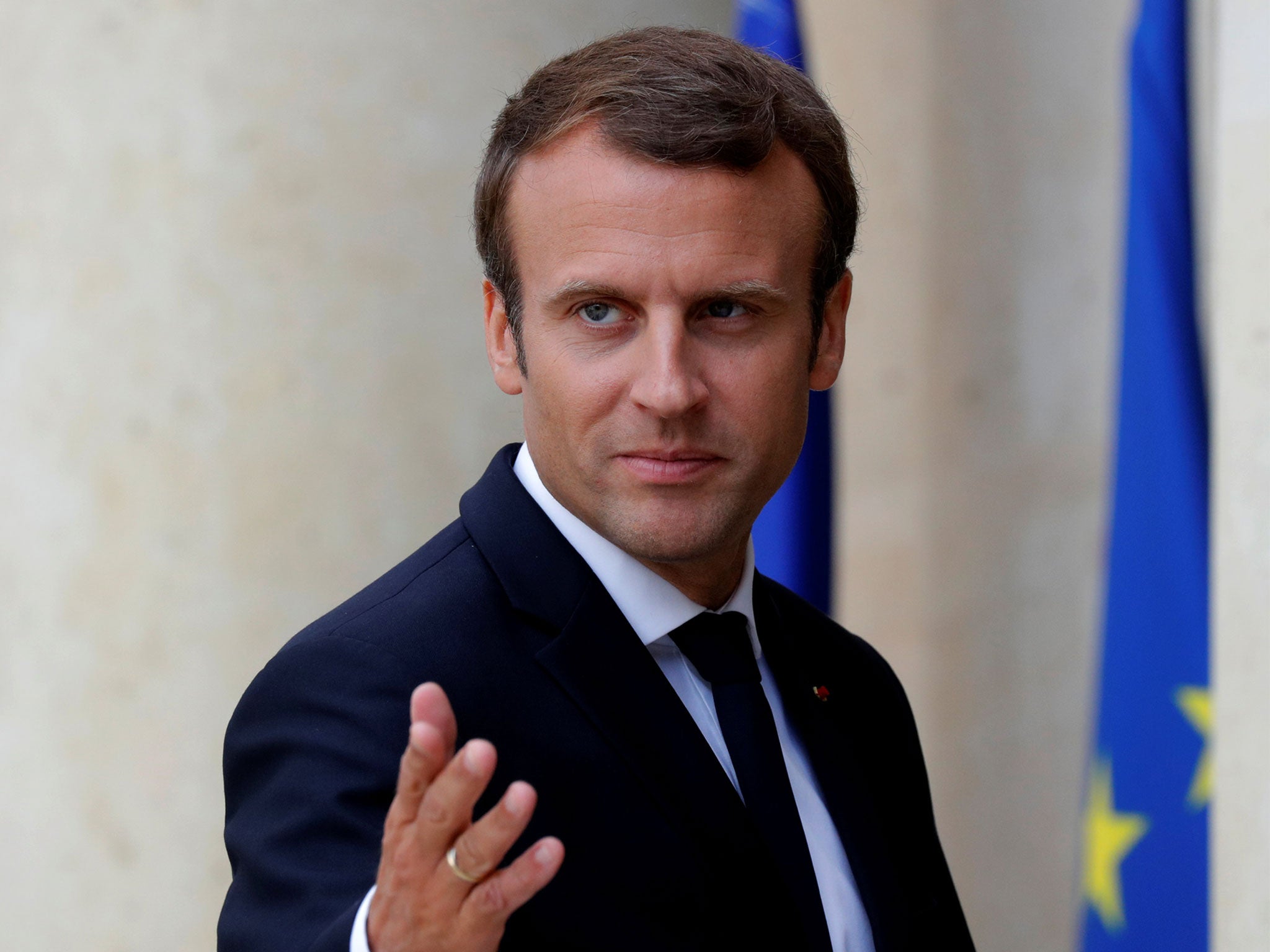 French President Emmanuel Macron accompanies guests after a meeting at the Elysee Palace in Paris