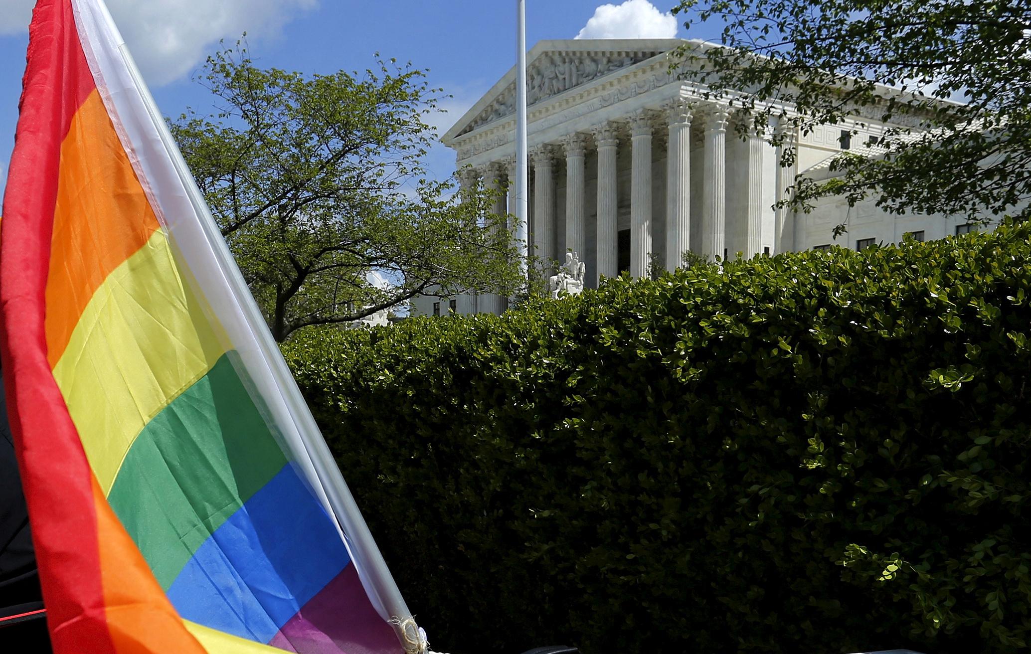 A rainbow coloured flag is seen outside the US Supreme Court in Washington