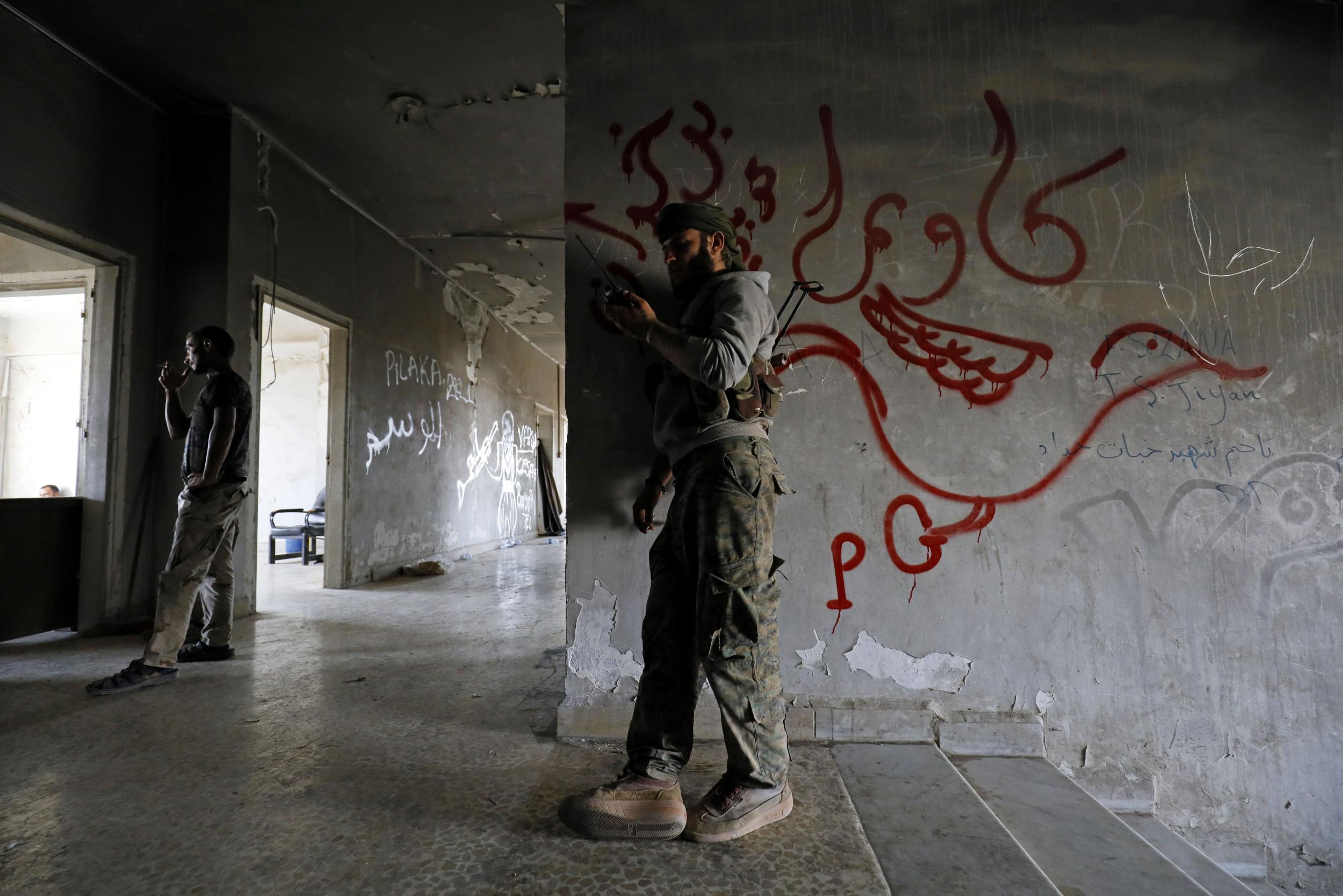 SDF fighters hold a position in Raqqa's eastern al-Sanaa neighbourhood, on the edge of the Old City, on 13 August 2017