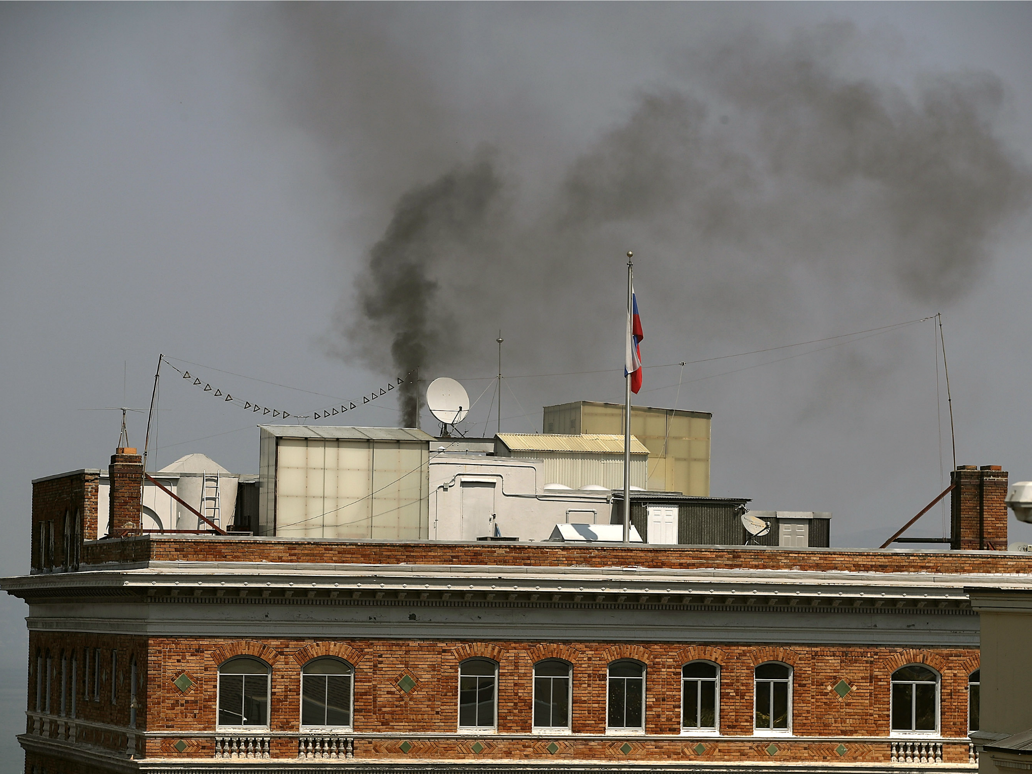 Black smoke billows from a chimney on top of the Russian consulate on September 1, 2017 in San Francisco, California.