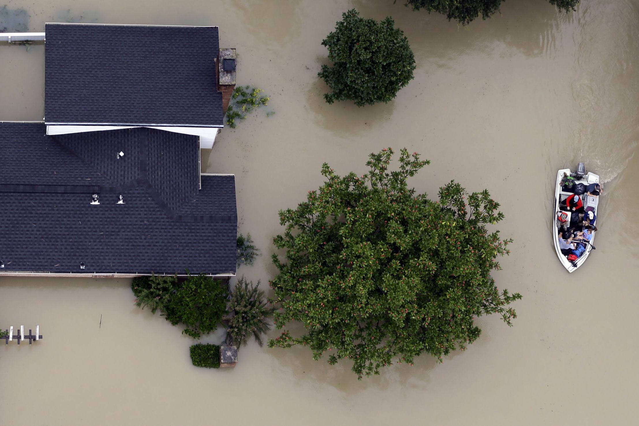 Residents evacuate their homes near the Addicks Reservoir as floodwaters rise in Houston