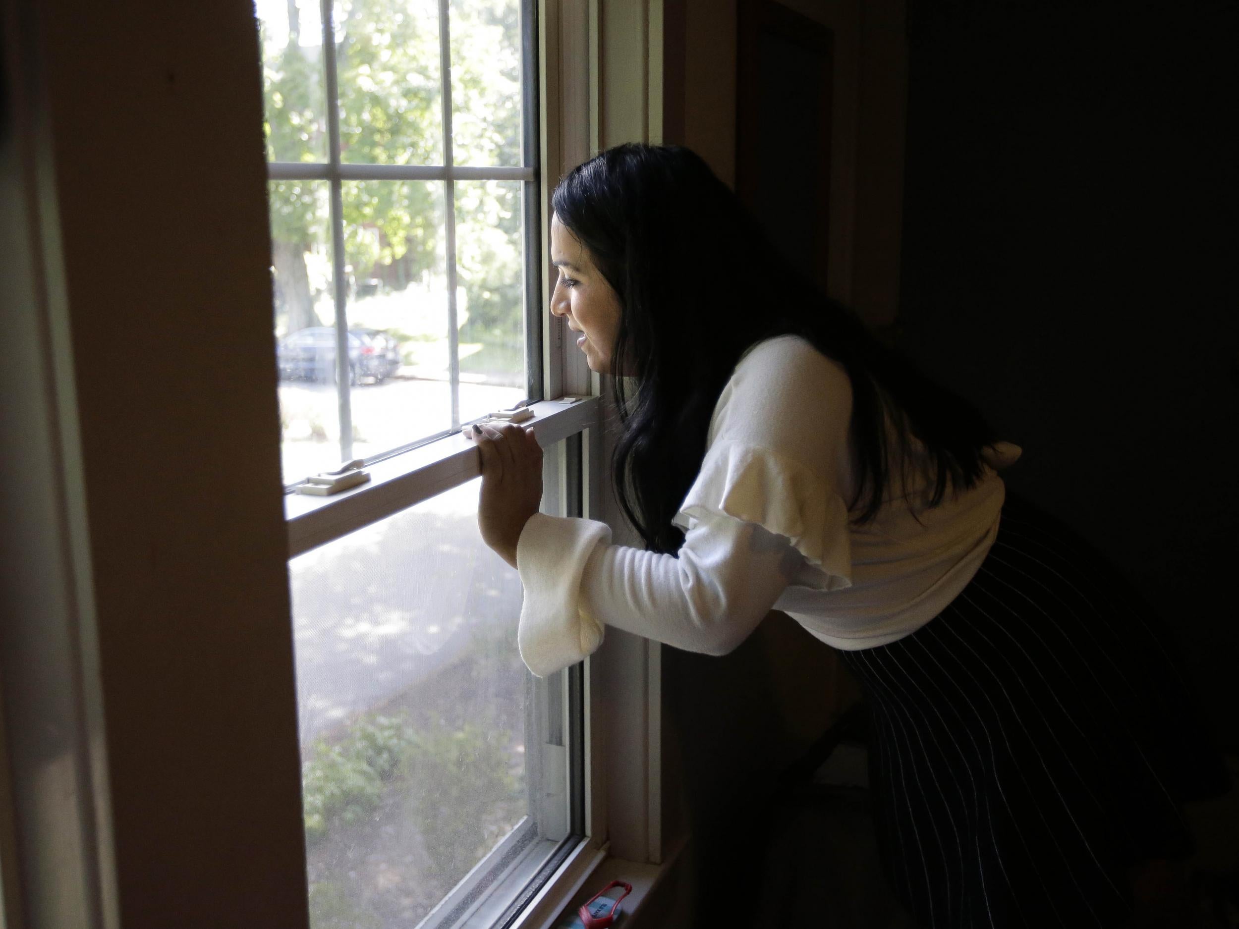 Ninotska Love, who has been accepted at Wellesley College, looks out a window in her dorm room at the women's school in Wellesley, Massachusetts