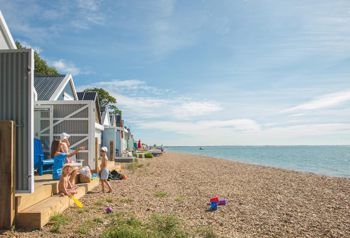 The huts sit on the shoreline, just above the highest tide mark