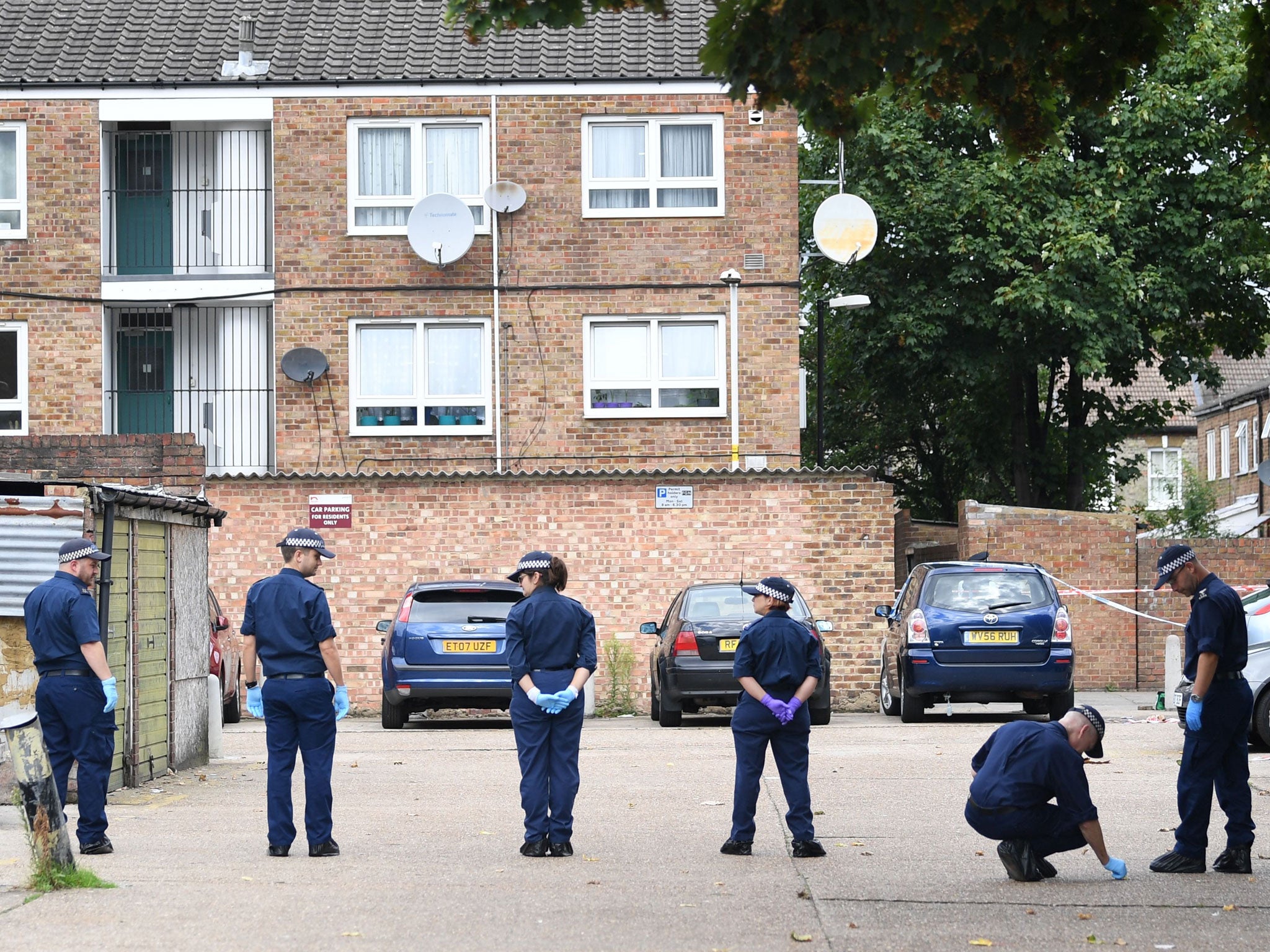 Police officers at the scene of the double shooting in Moore Walk