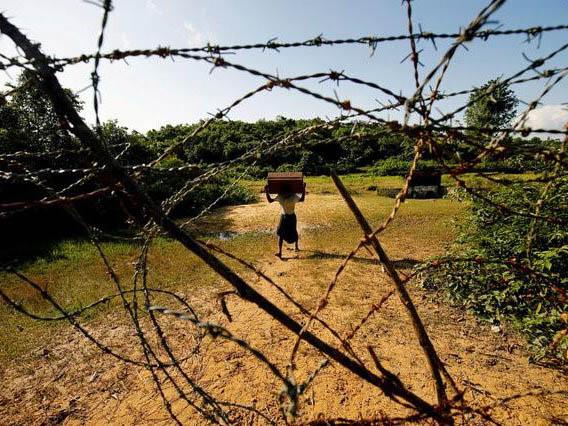 A Rohingya man carrying his belongings approaches the Bangladesh-Burma border in Bandarban