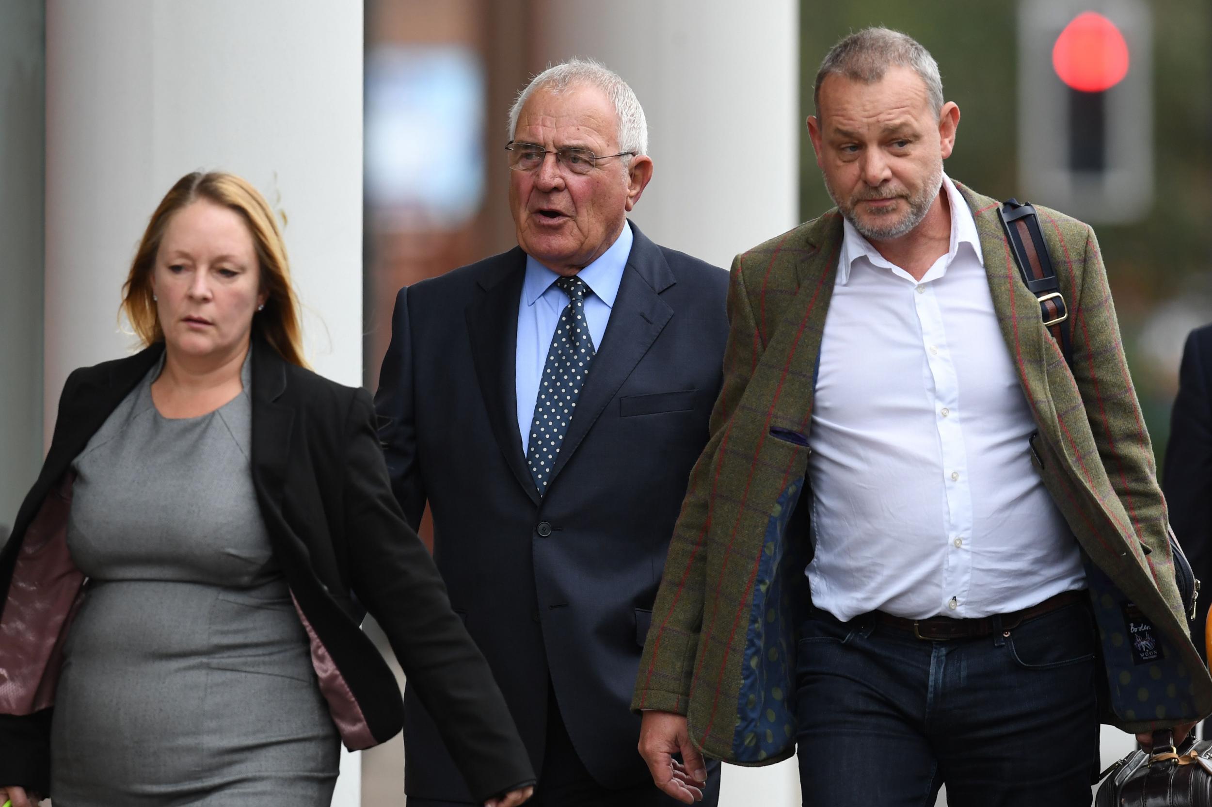 Retired police officer Donald Denton (centre) arrives at court in Preston