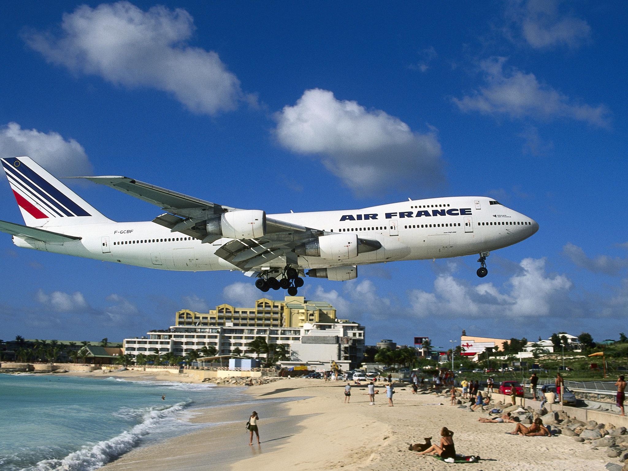 Princess Juliana International Airport is famed for planes flying over beach-goers' heads as plane spotters cling to fences to feel the jet blast of aircraft taking off