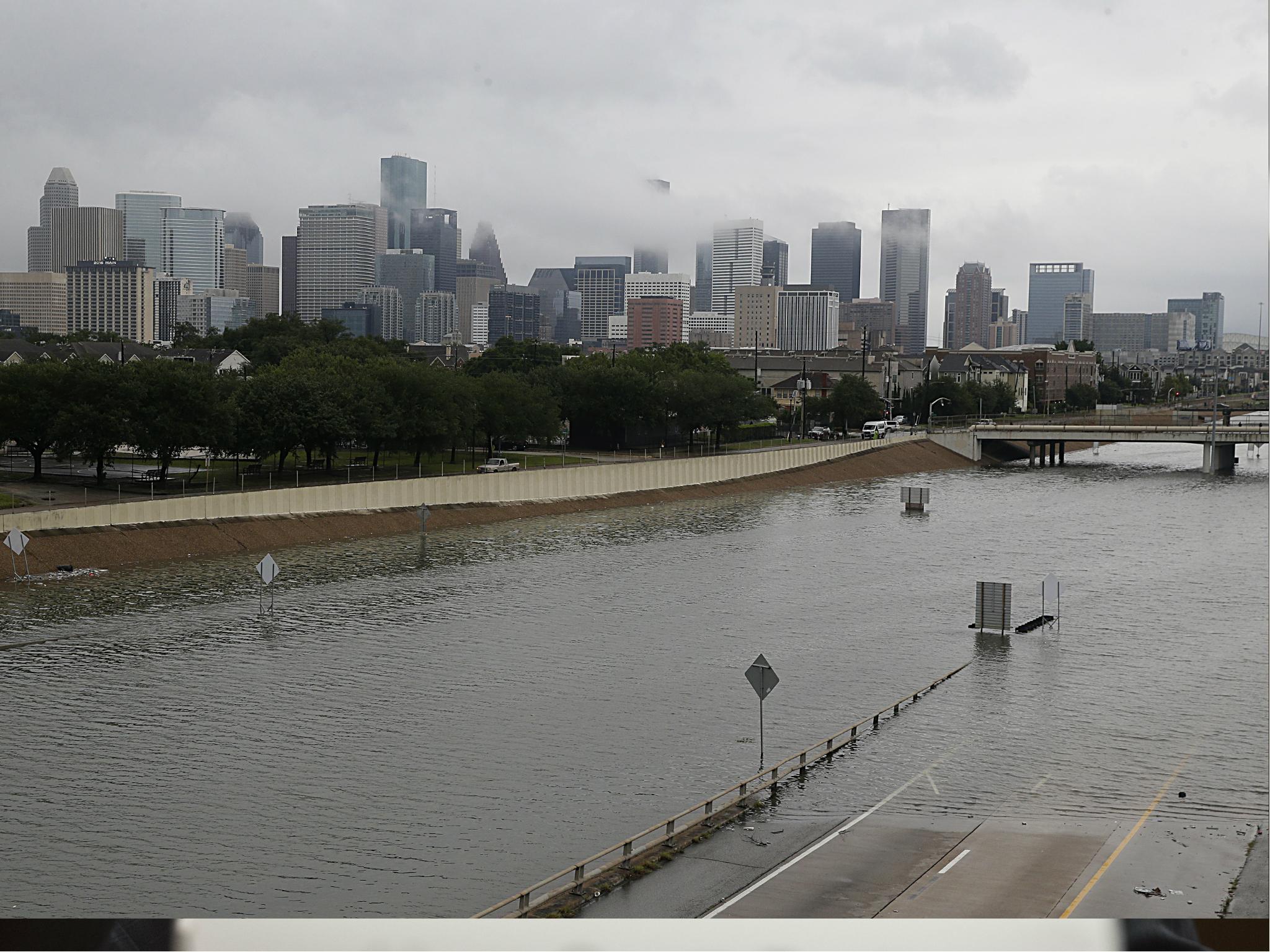 The downtown Houston skyline and flooded highway 288 are seen 27 August 2017