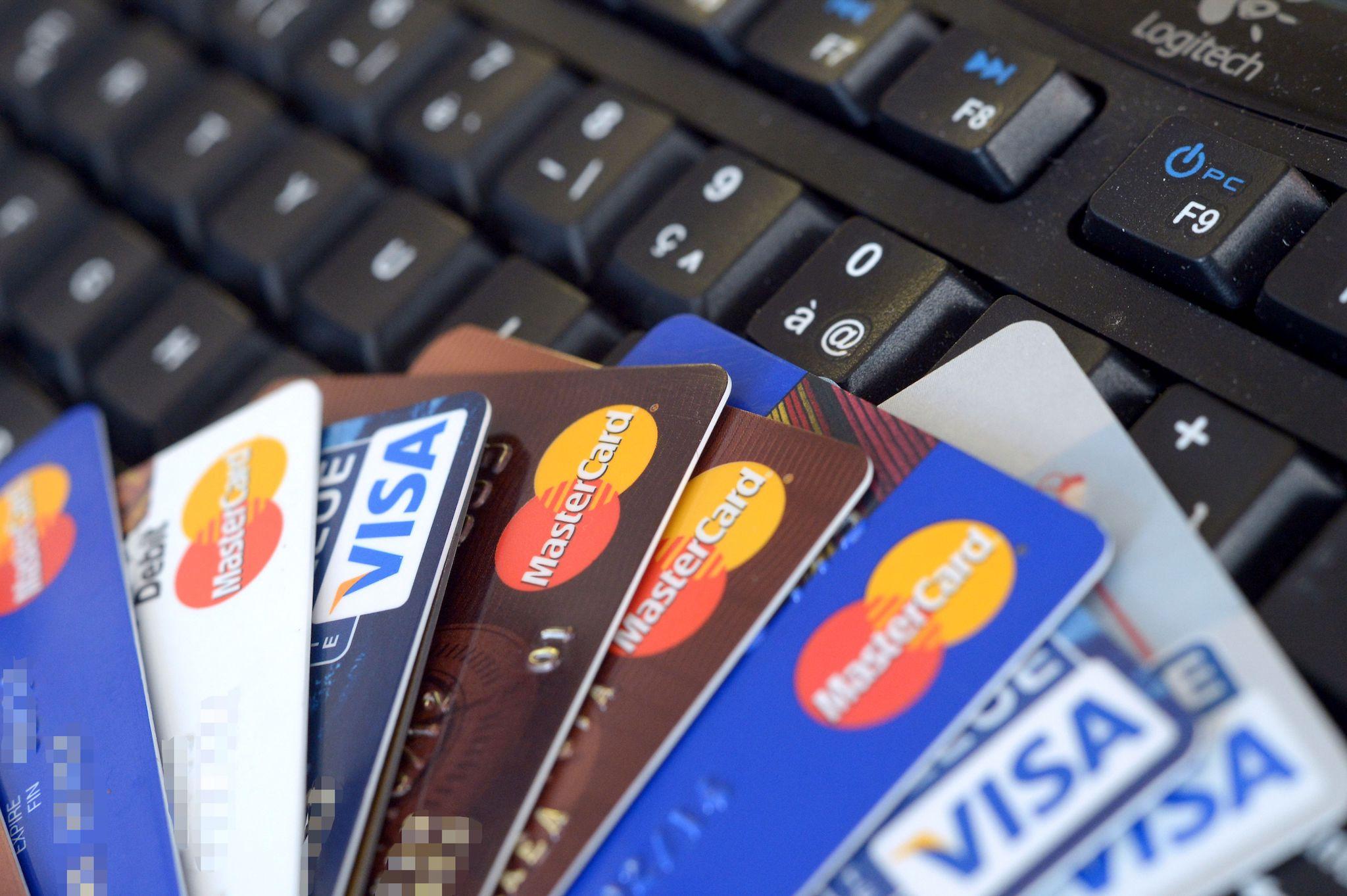 Credit cards are pictured on a computer's keyboard on February 5, 2013 in Rennes, western France