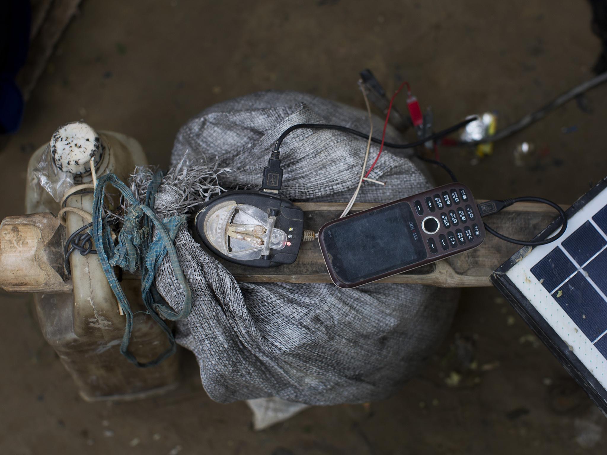 A mobile phone is charged by a solar panel