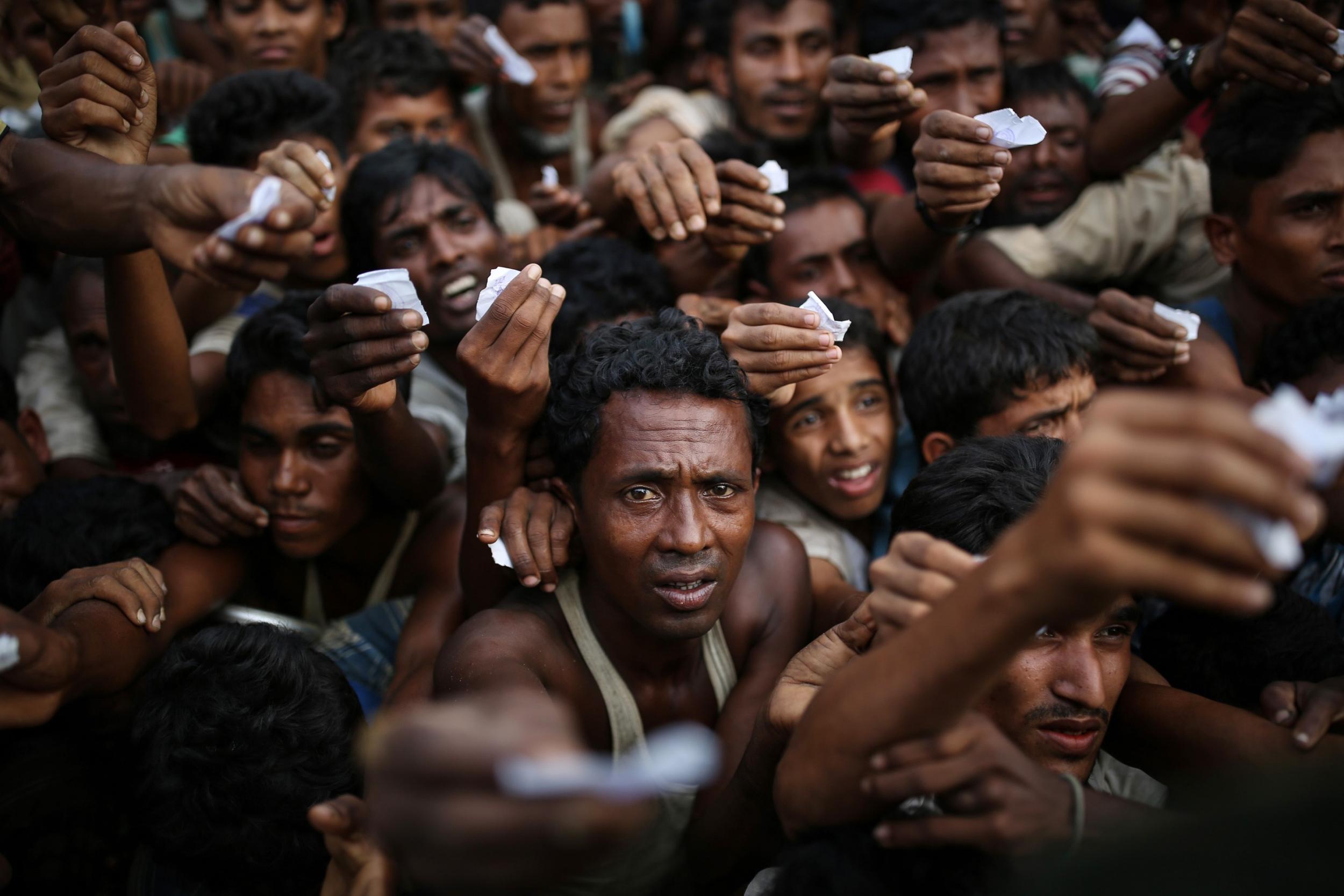 Rohingya Muslims, fleeing from ongoing military operations in Burma's Rakhine state, try to take food aid at a refugee camp 50 kilometres south of Cox's Bazar, Bangladesh