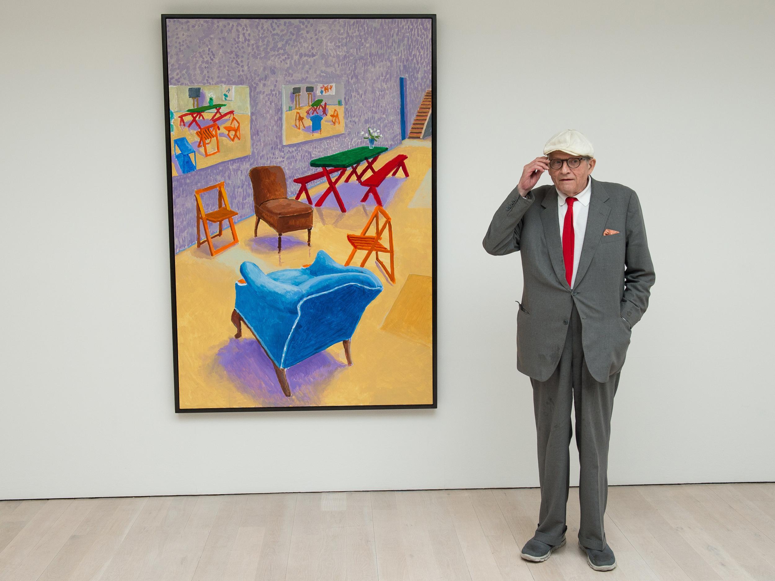 Hockney poses with his painting ‘Studio Interior #4 2014-2015’ (AFP/Getty)